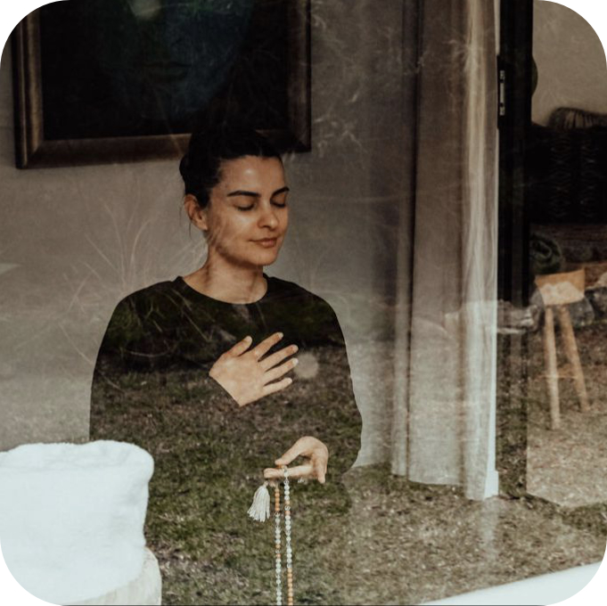 Woman doing mantra japa with one hand on her chest