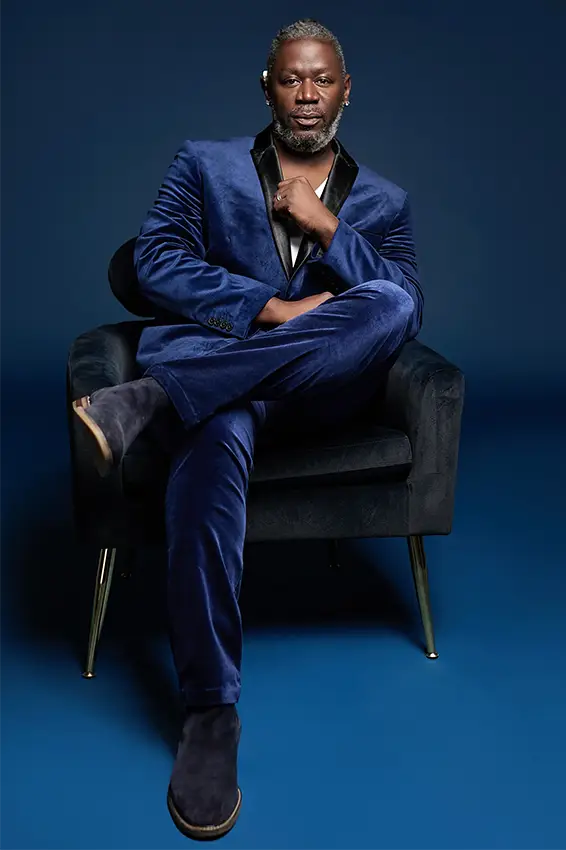 Warren Snipe sitting in a chair wearing a blue suit