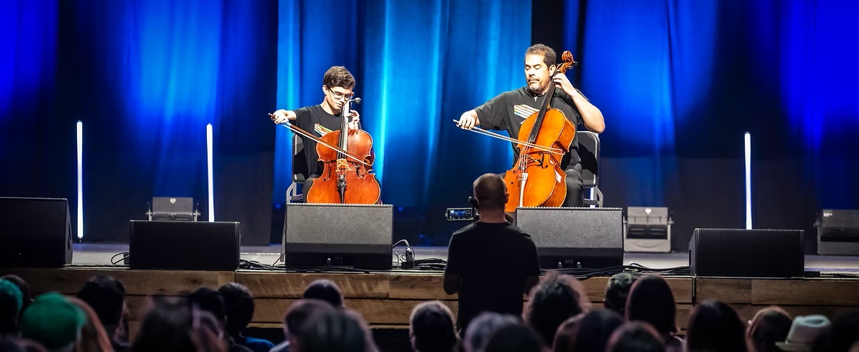 two persons playing chello