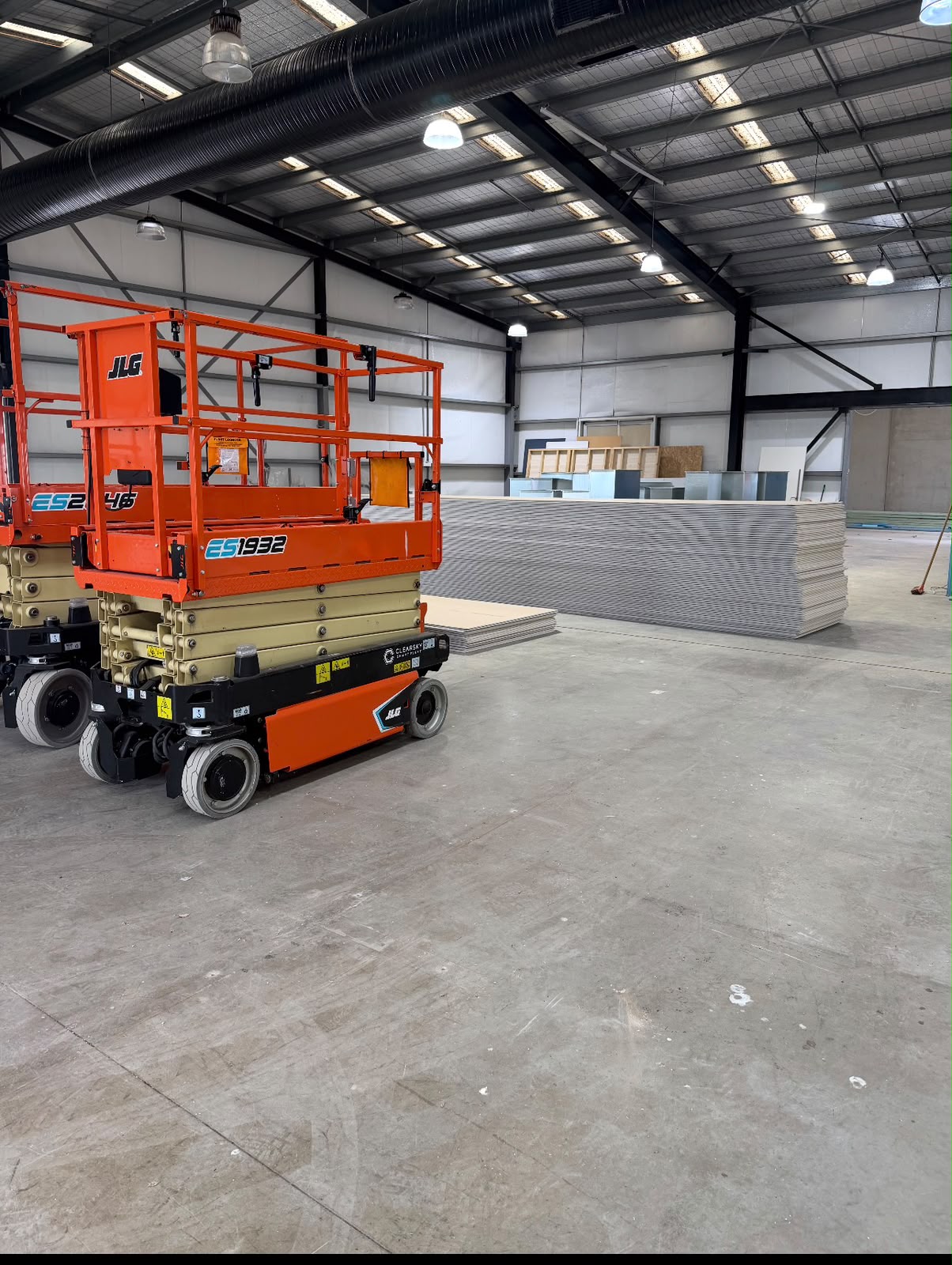 Orange scissor lift during construction inside the second Totally Pumped Dalmahoy building