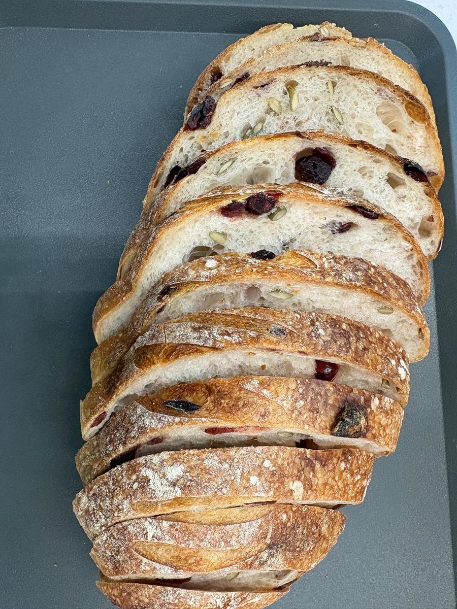 A whole Cranberry sourdough loaf, sliced right down its length