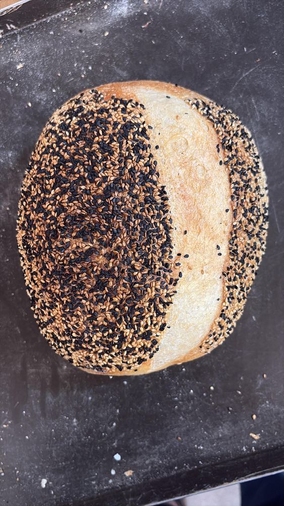 Sesame sourdough loaf topped with black and white sesame seeds