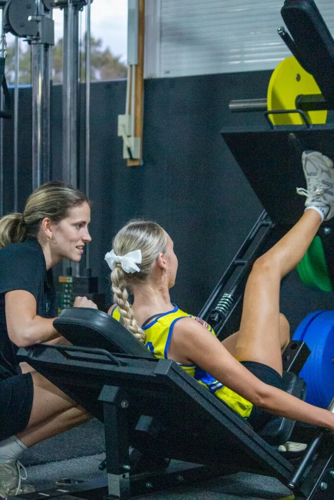 Young athlete with patellofemoral pain doing knee pain treatment exercises under supervision Young athlete with patellofemoral pain doing knee pain treatment exercises under supervision