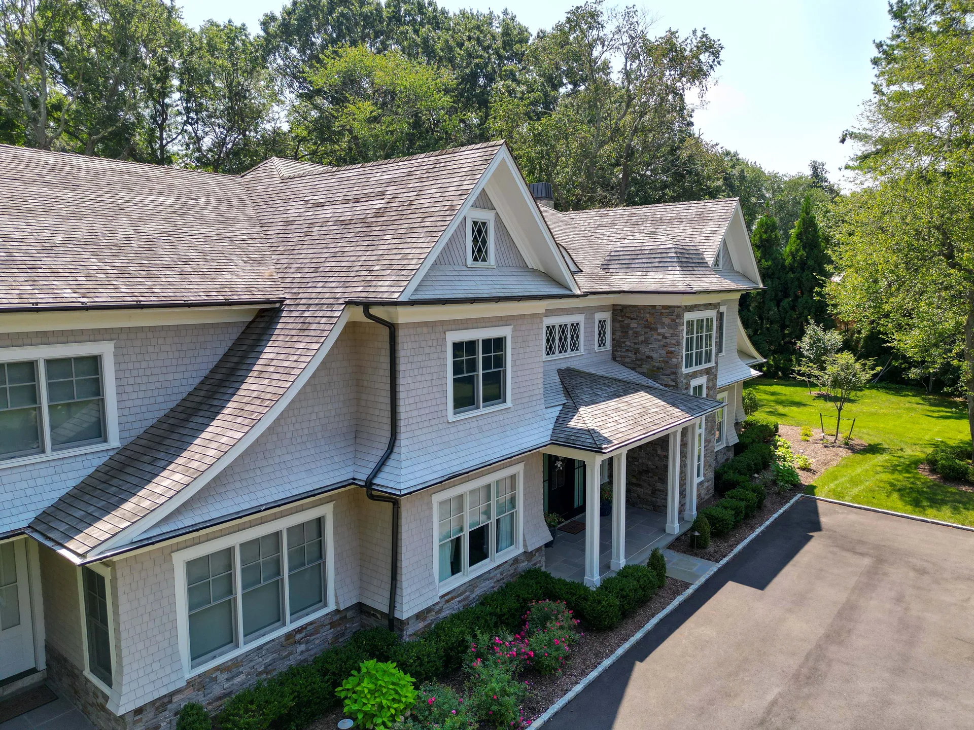Brookville Cedar Estate, a completed Prestige custom home, from above: cedar shingles, stone base and the covered entry