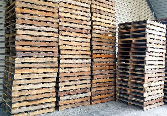Pallets stacked under a shed roof