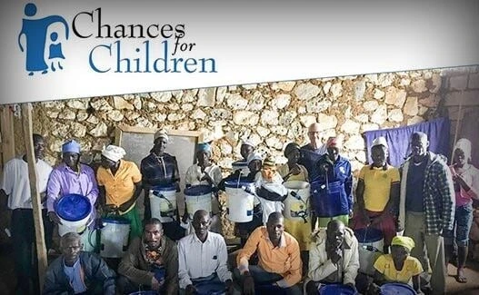 Chances for Children community meeting with African villagers receiving support and education