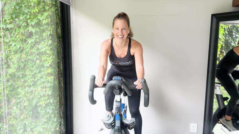 Smiling member on an indoor bike