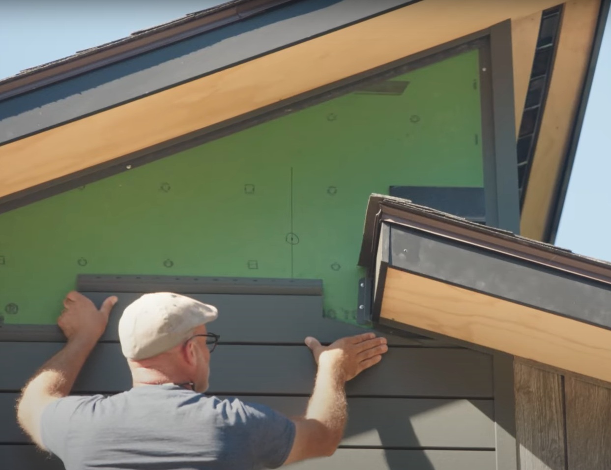Lawrenceville Siding contractor measuring siding at a Gwinnett County job site