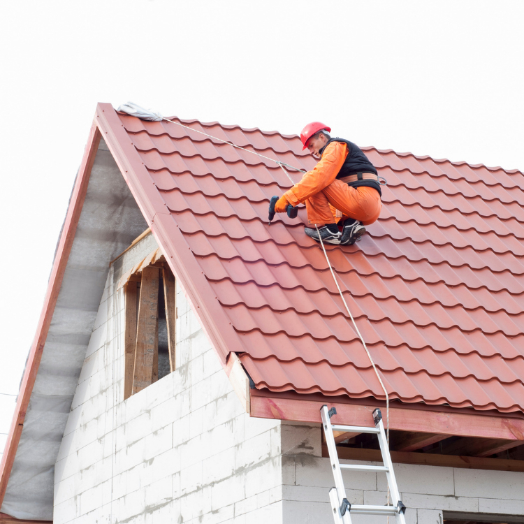Worker on a tile roof