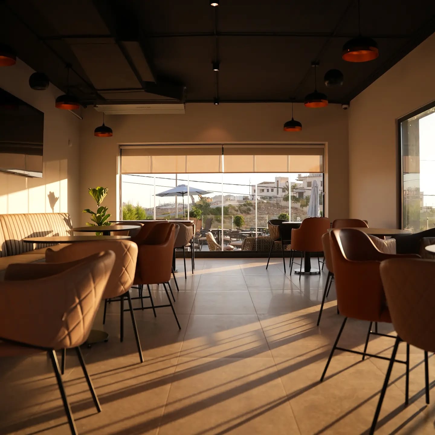 Wide view of multiple padel courts with green surfaces