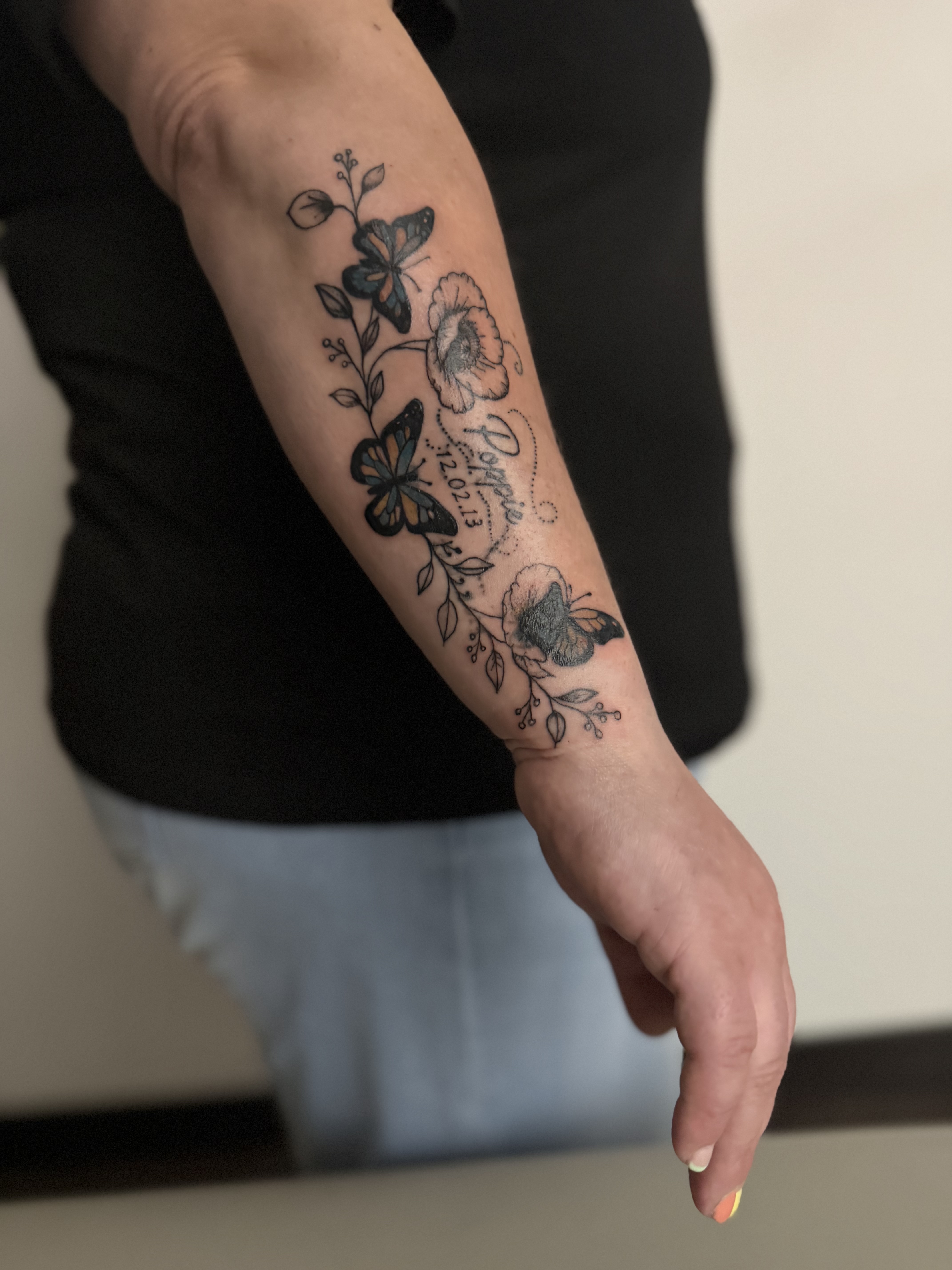 Colour floral and butterfly memorial tattoo by XXII Ink