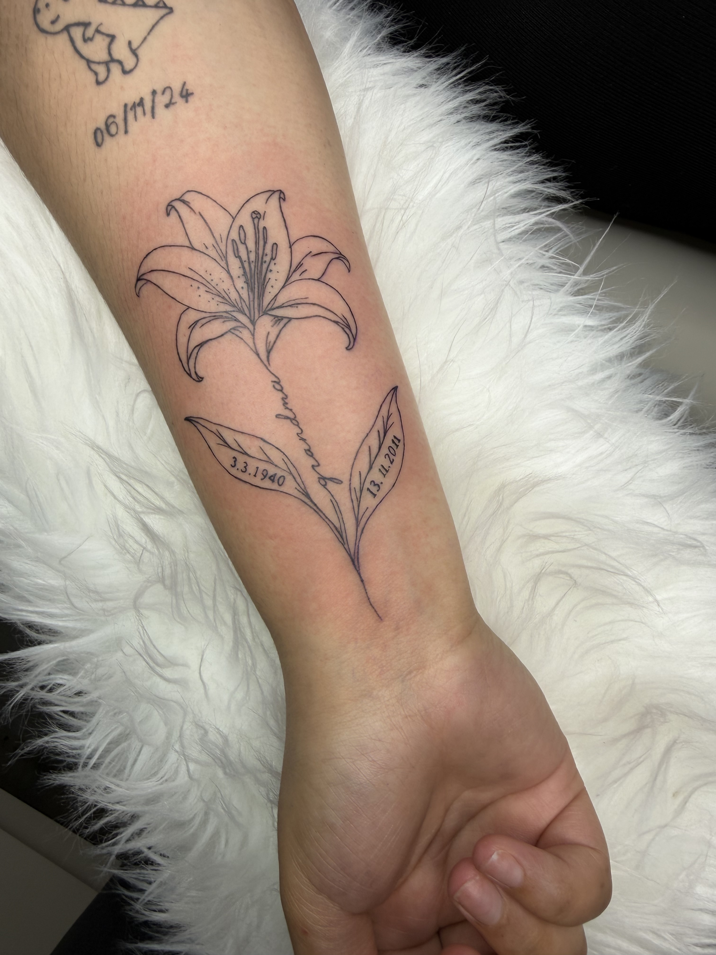 Memorial lily fine-line tattoo by XXII Ink