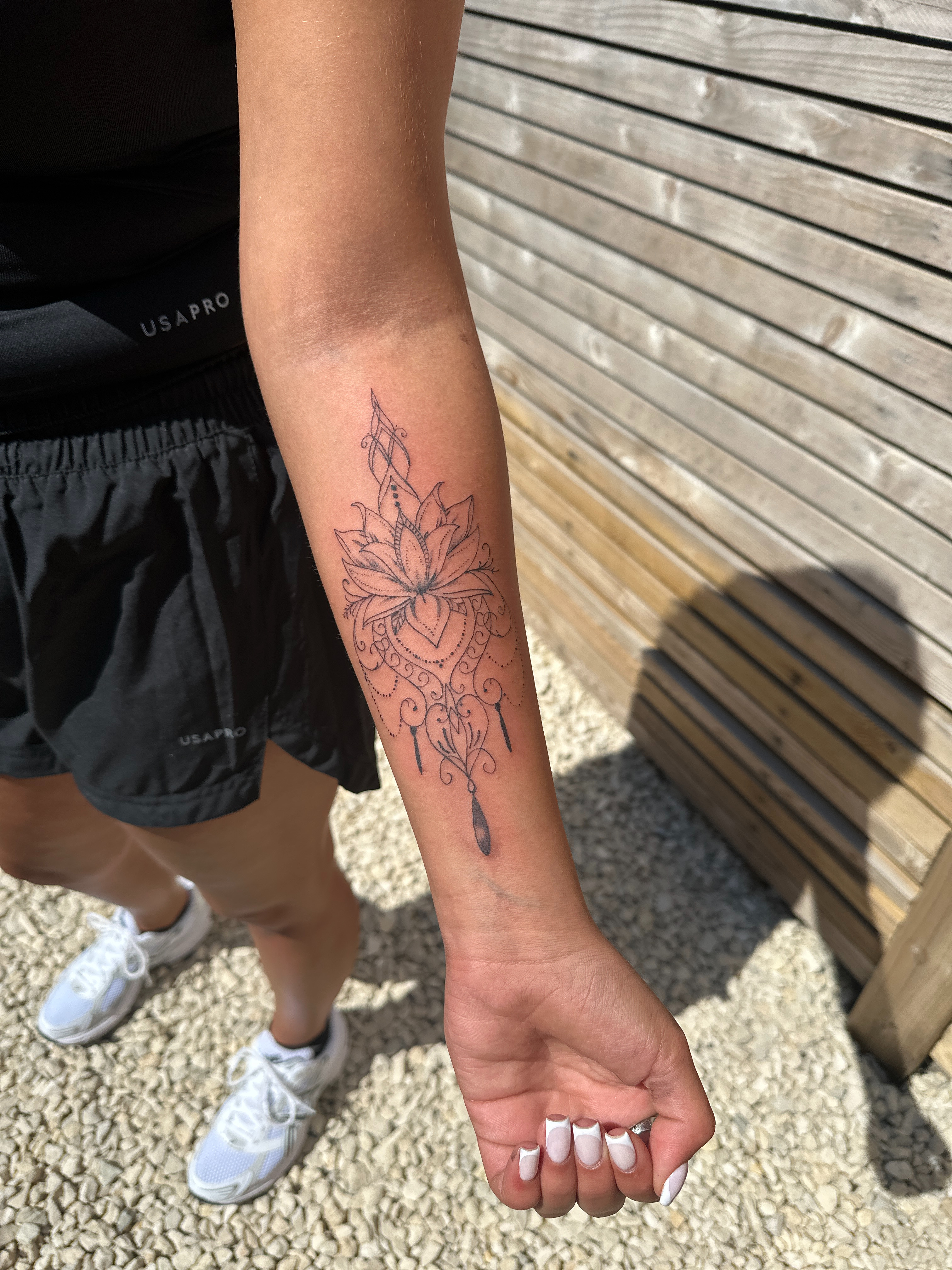 Ornamental lotus mandala forearm tattoo by XXII Ink