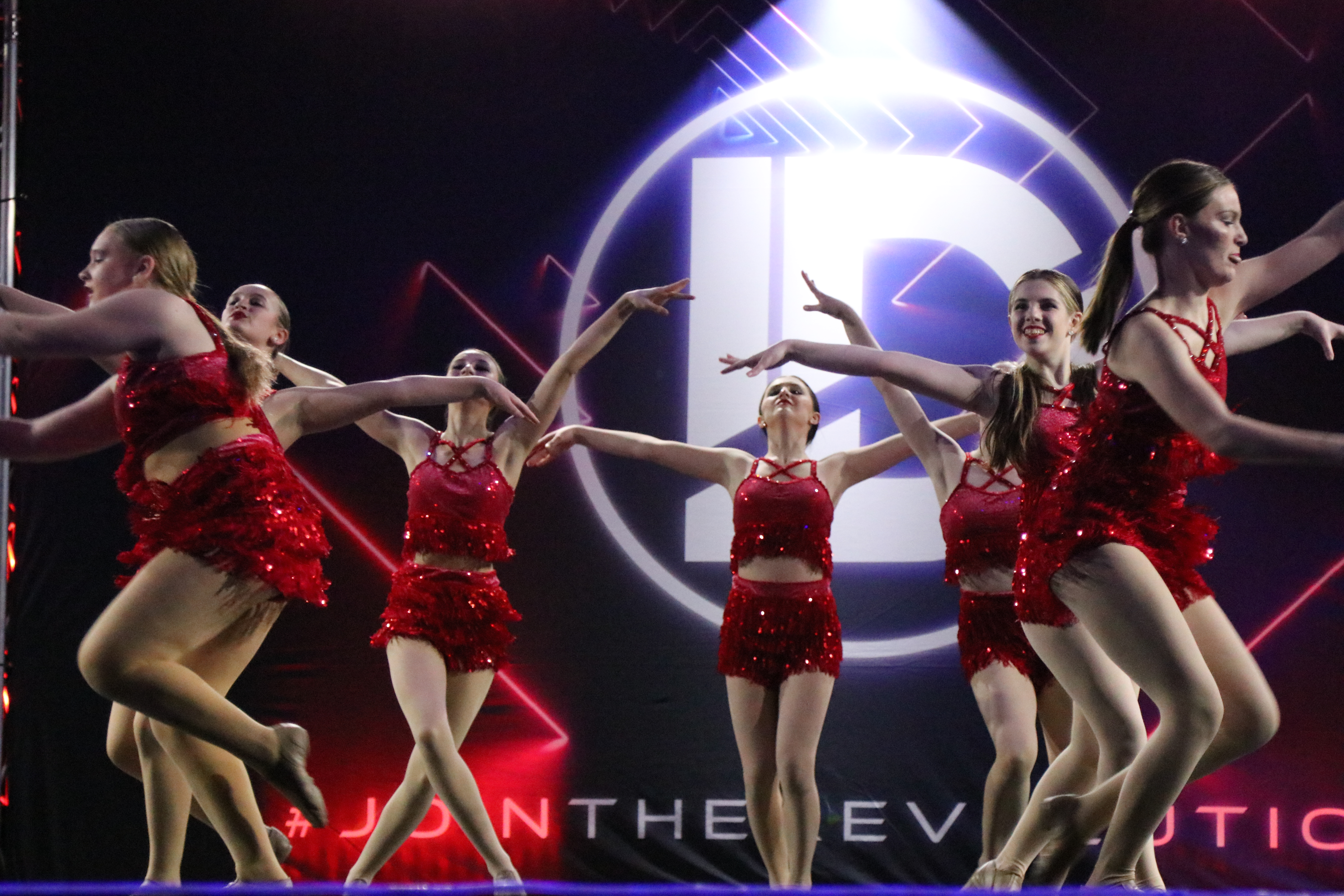 Dancers in red costume on stage