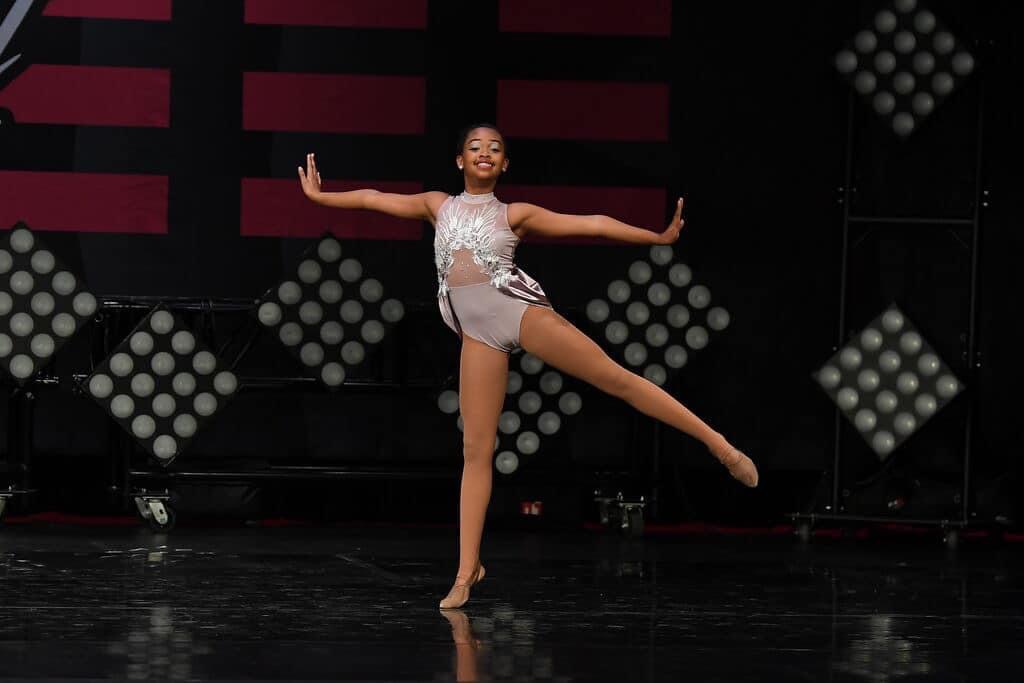 Solo dancer in lilac costume on stage