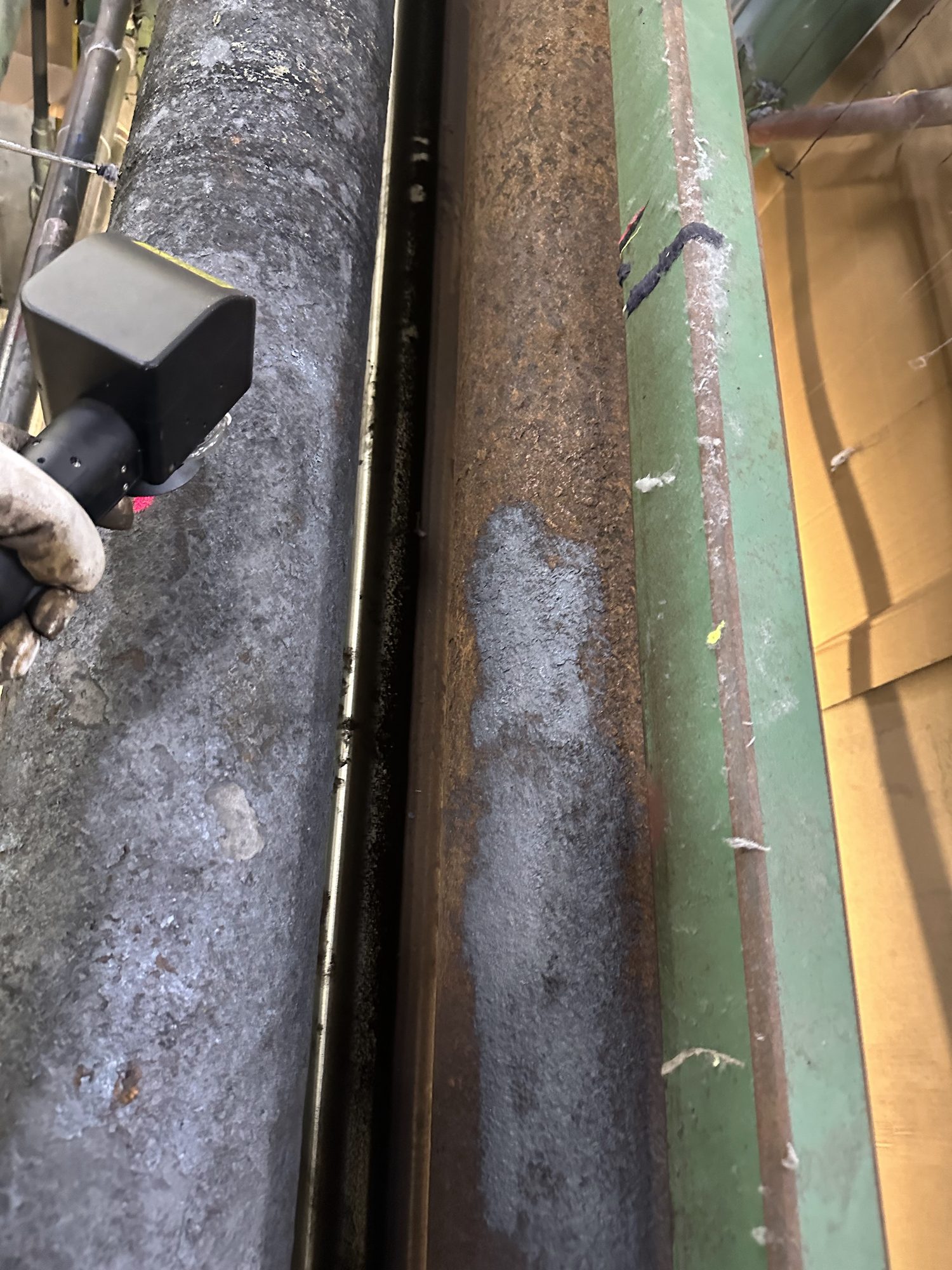 A laser test patch on a rusted roller shows bare metal where the head has passed.