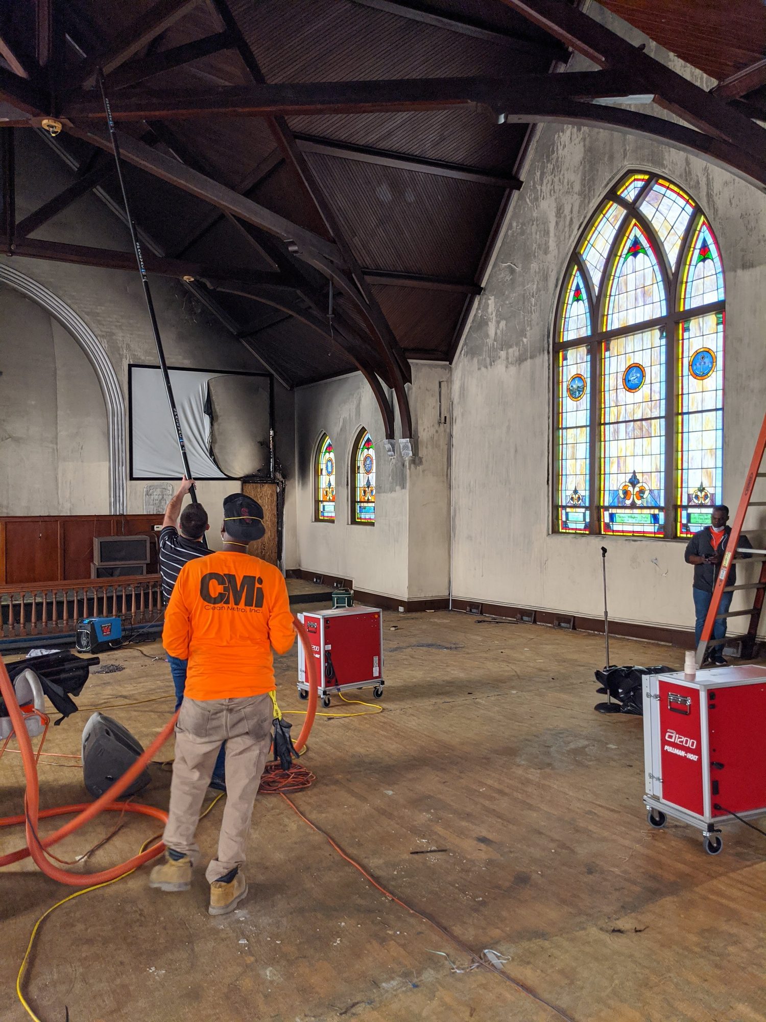Clean Metro crew running air scrubbers during soot cleanup inside a church sanctuary
