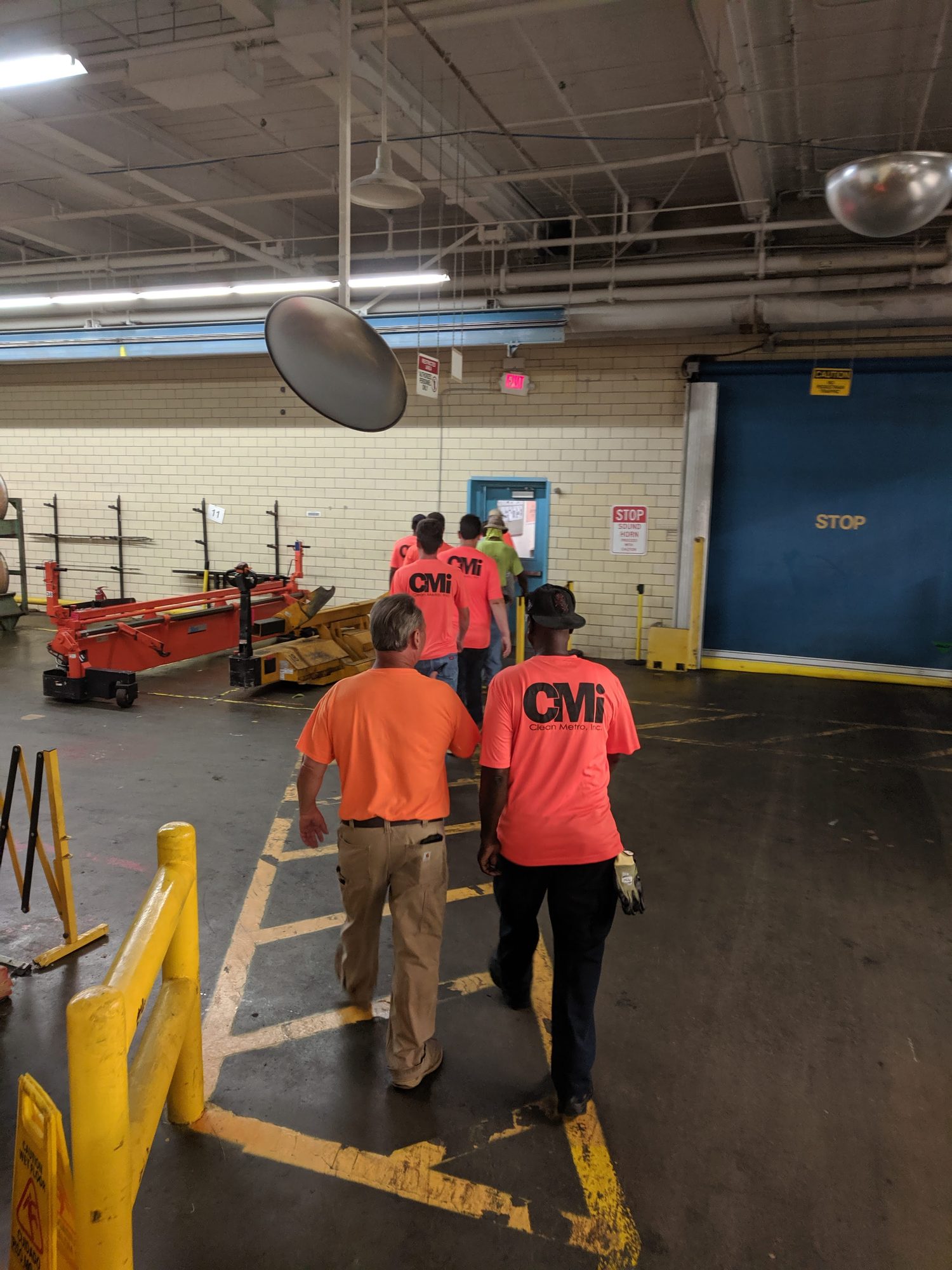 CMI crew in branded shirts walks into a plant to start a shift.