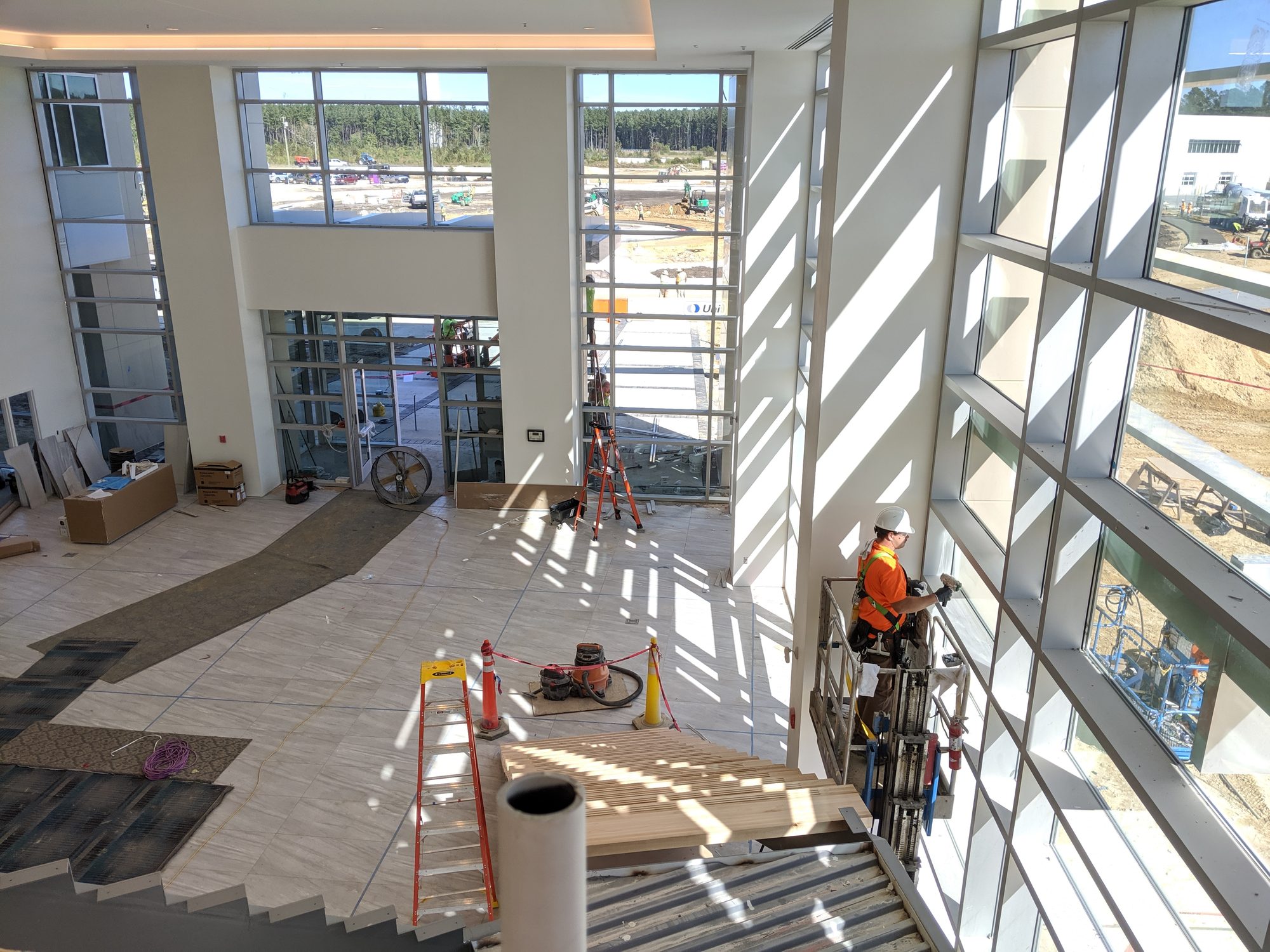 Crew on a lift cleaning atrium glass during construction final clean