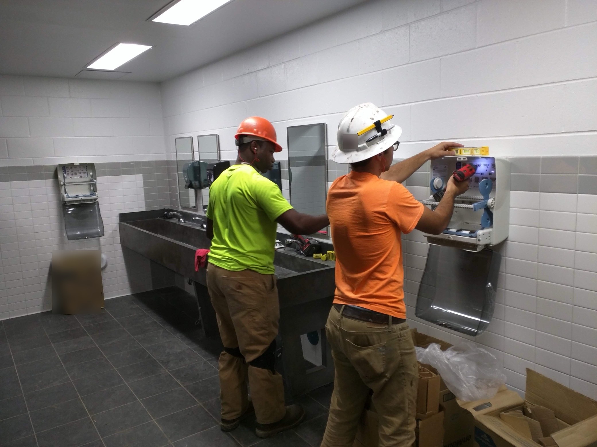 CMI crew installs paper towel dispensers at the start of a janitorial program in a new 600,000 sq ft manufacturing plant.