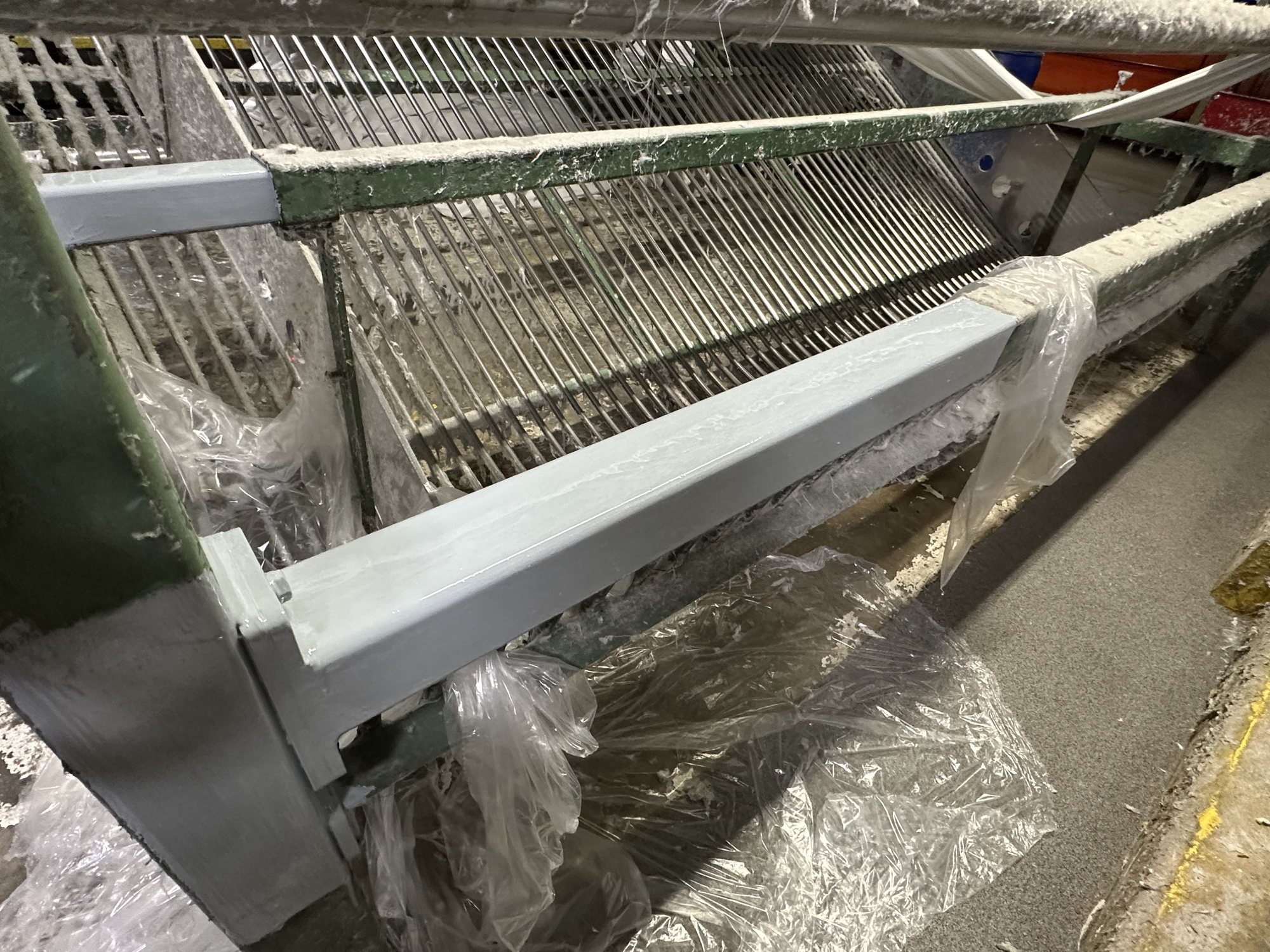 The machine frame crossmember finished in fresh gray coating after laser cleaning and priming.
