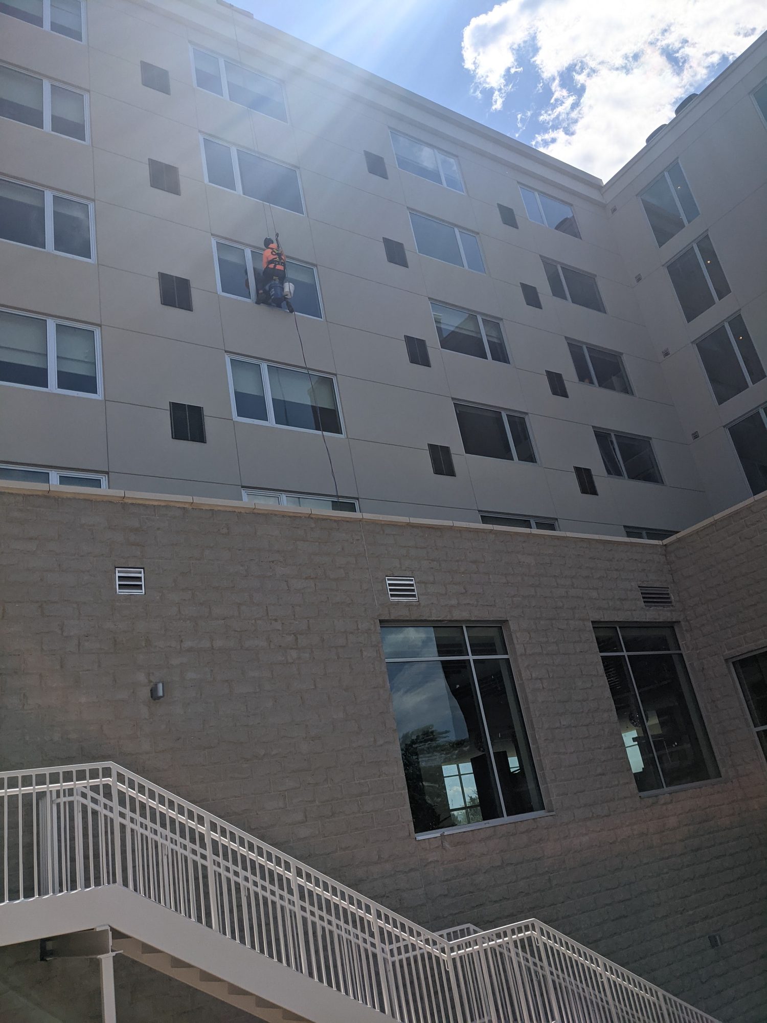 Rope access in the hotel courtyard, where no lift could reach the upper floors.