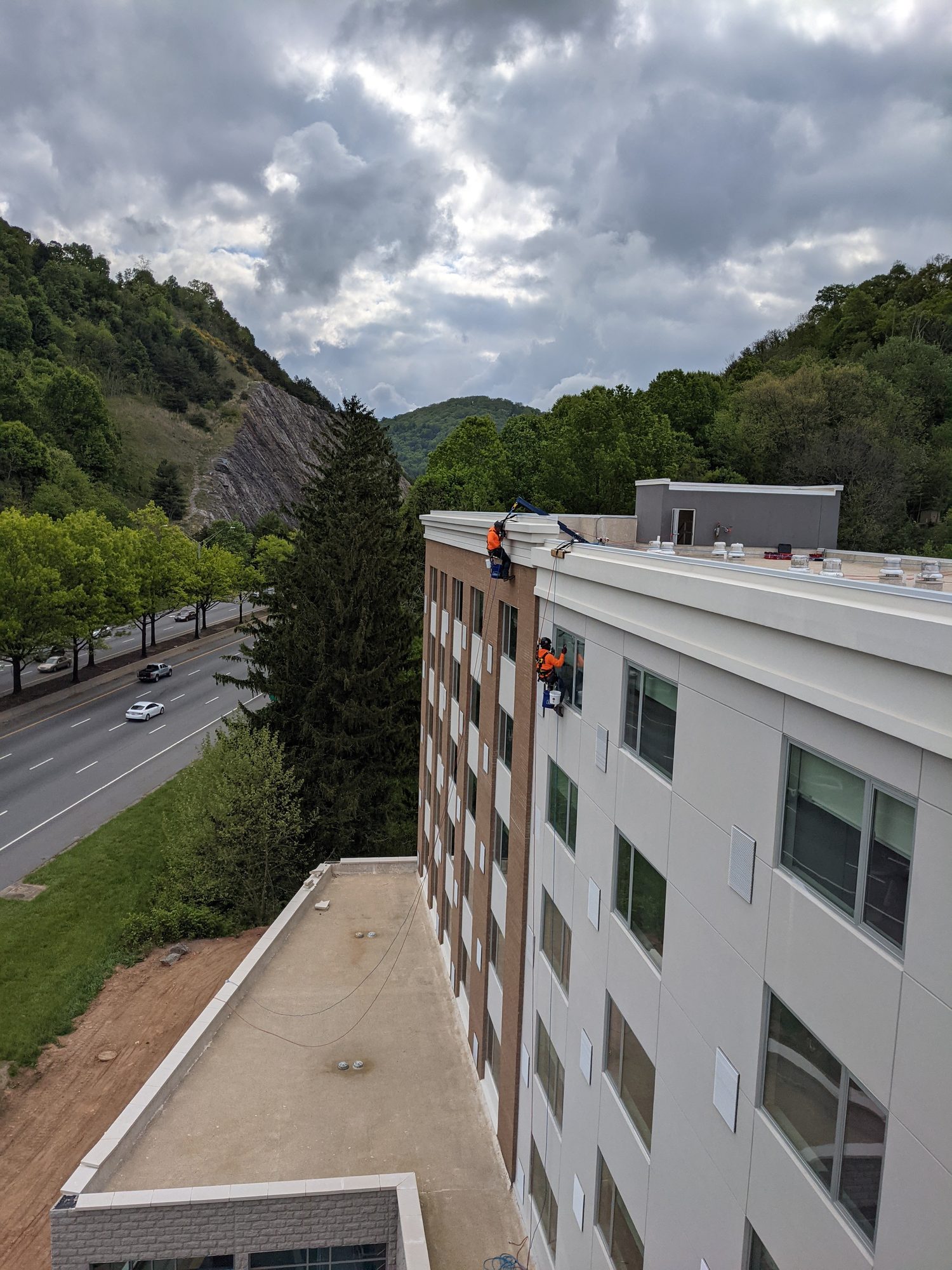 From the roof of the Element by Marriott in Asheville: CMI rope access techs working down the facade above the highway.