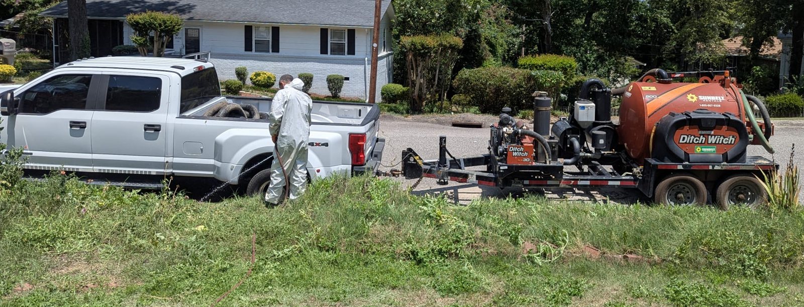 The trailer unit tows behind a pickup and sets up on the street, so no heavy truck rolls onto the lawn.