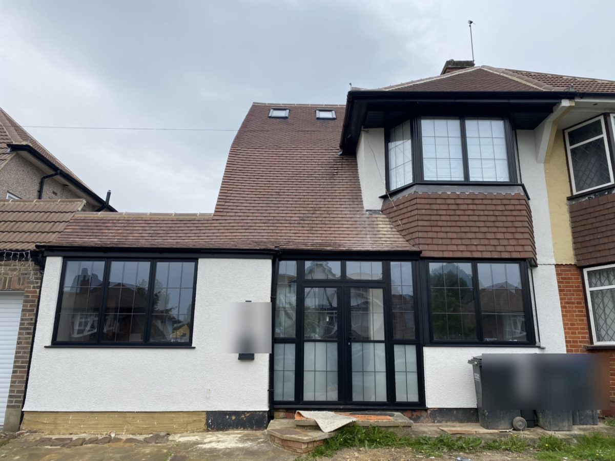 After: white render and black aluminium windows and doors