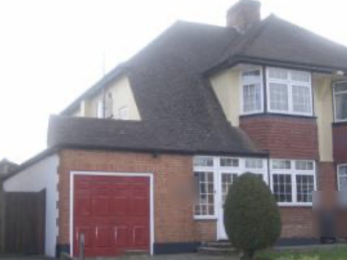 Before: brick front with a red garage door