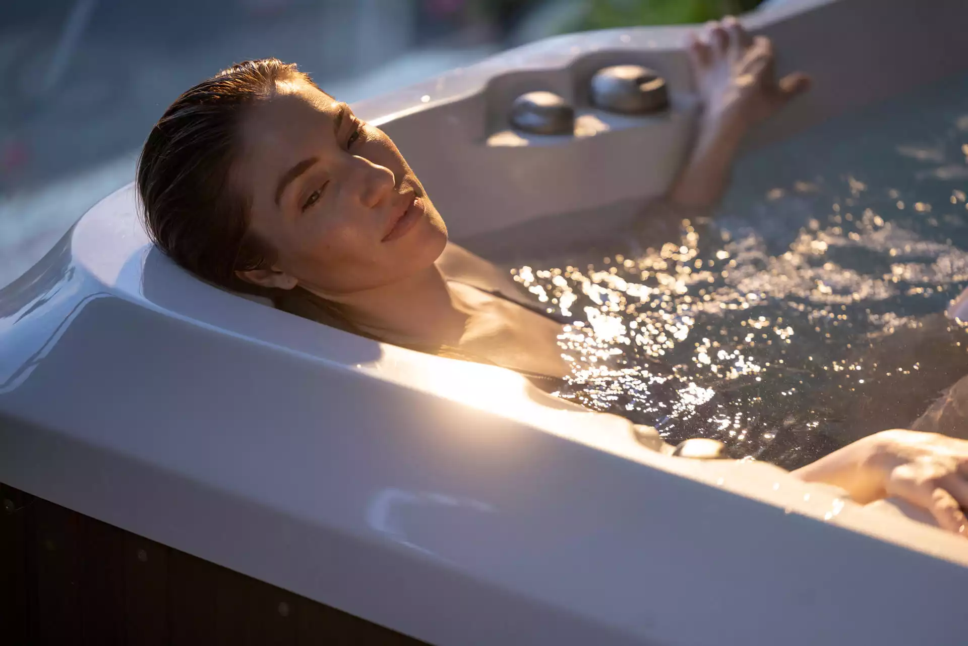 Woman relaxing in Jacuzzi® Hot Tub
