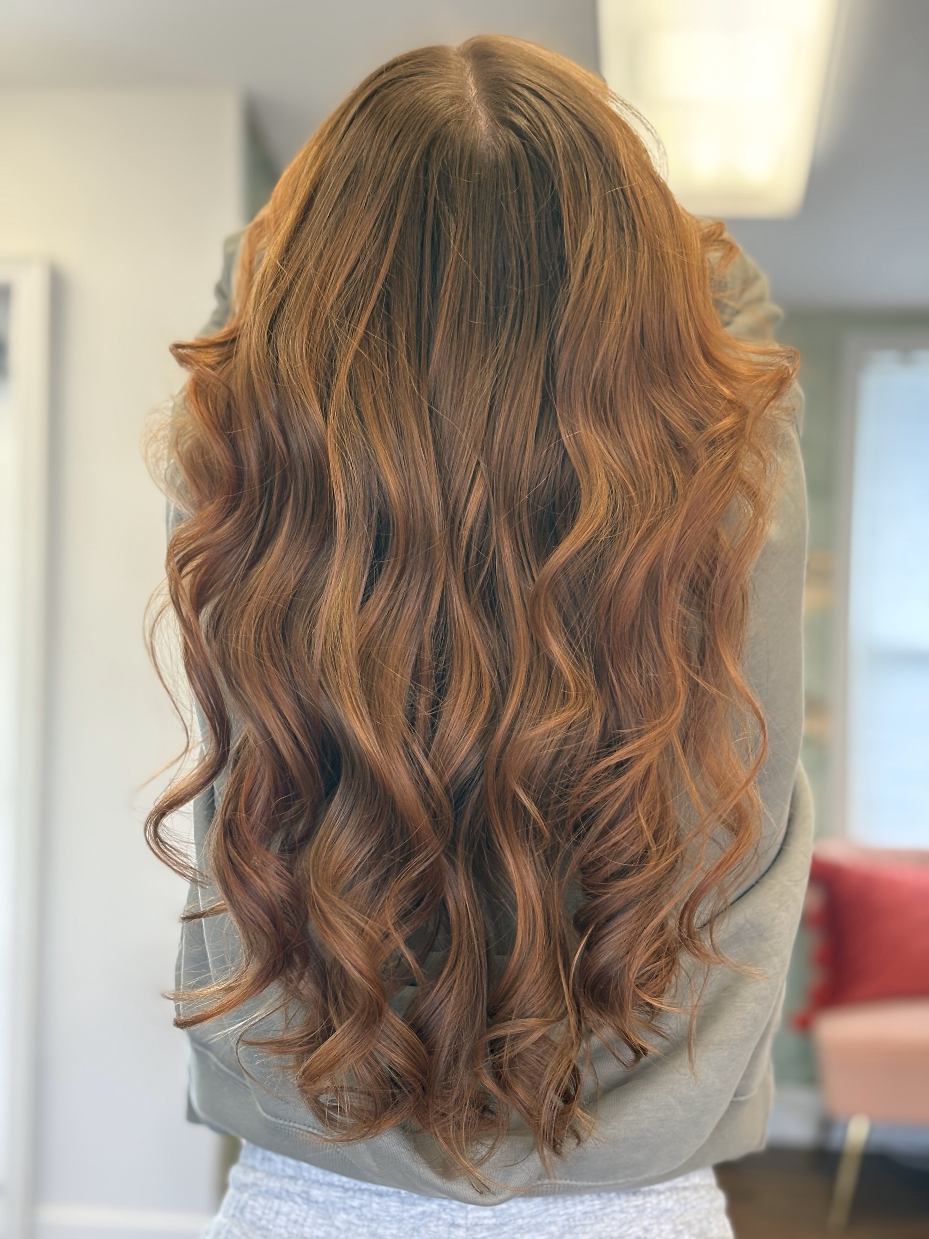 Finished dimensional caramel balayage custom color by Jessica Young — face-framing layers with soft wave, full head visible