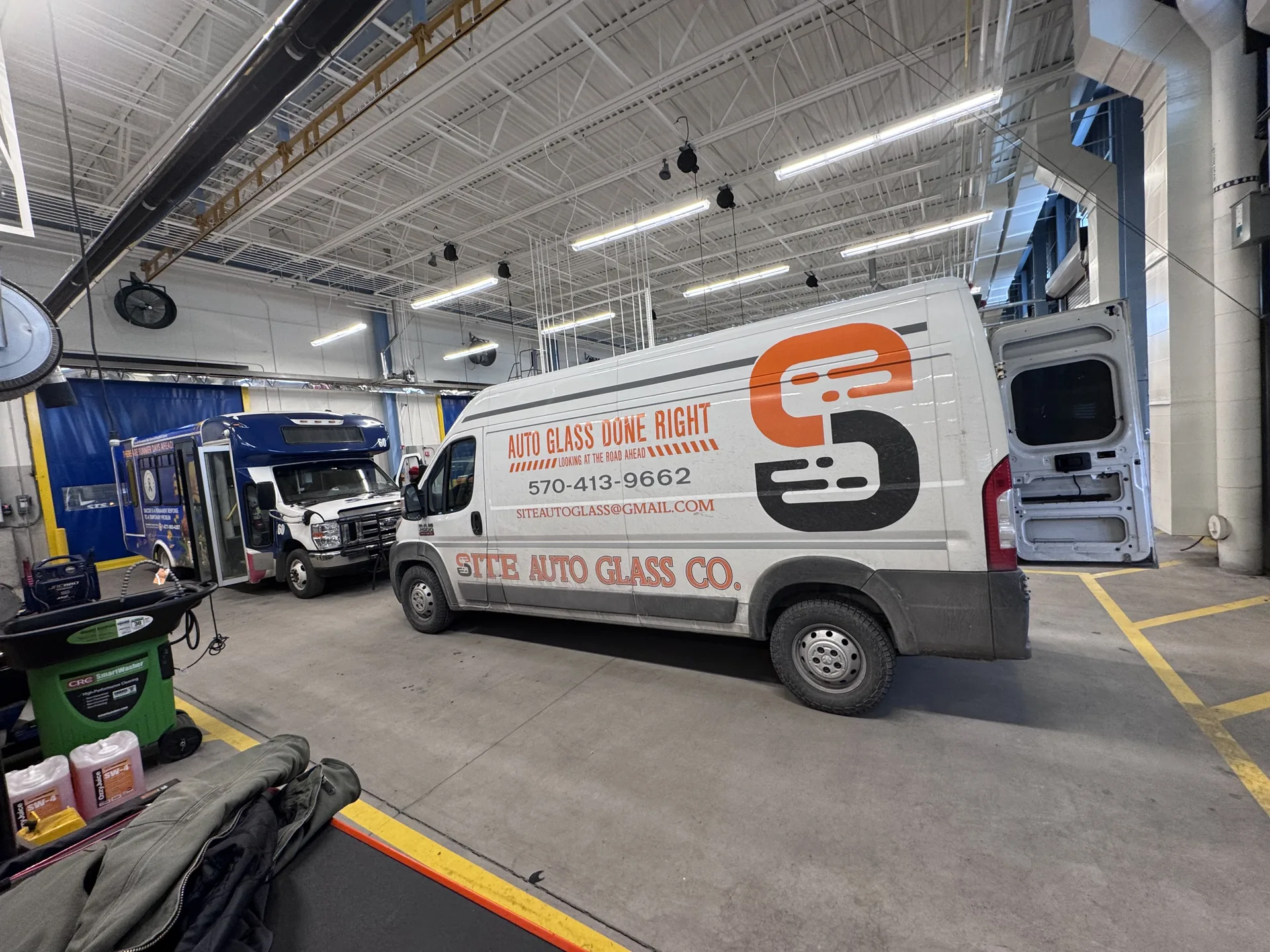 Site Auto Glass Co. branded mobile service van in orange and black with 'Auto Glass Done Right' decals