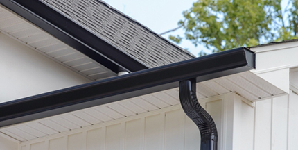 Newly installed gutter along a roofline