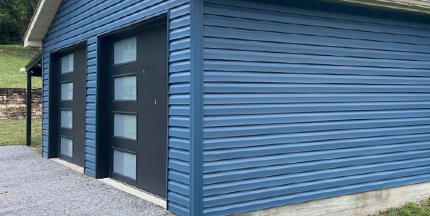 Newly installed siding on a garage exterior
