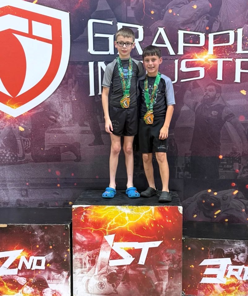 Will and Ryder on the tournament podium with their medals