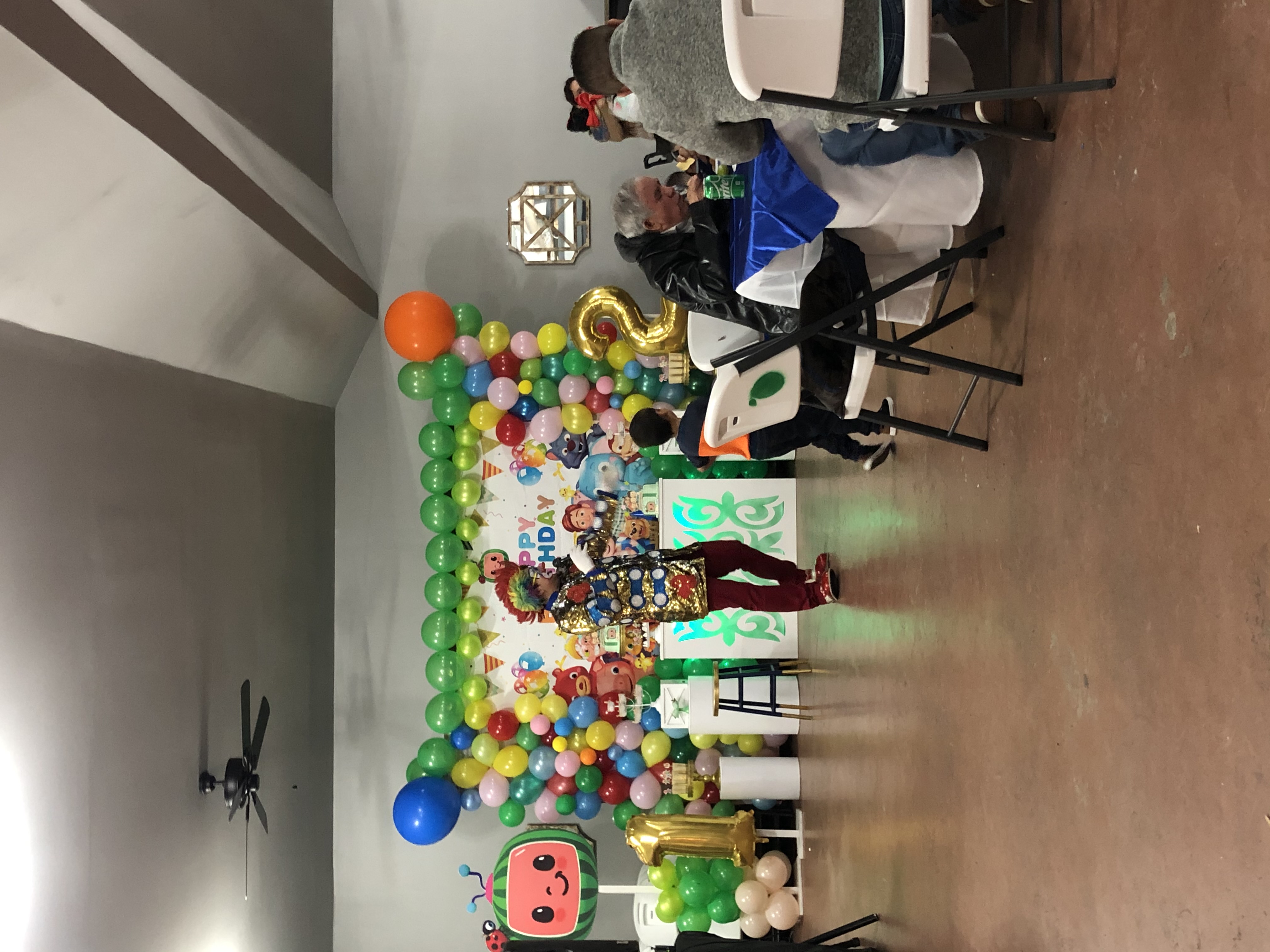 Children's birthday party with a colorful balloon arch and themed backdrop