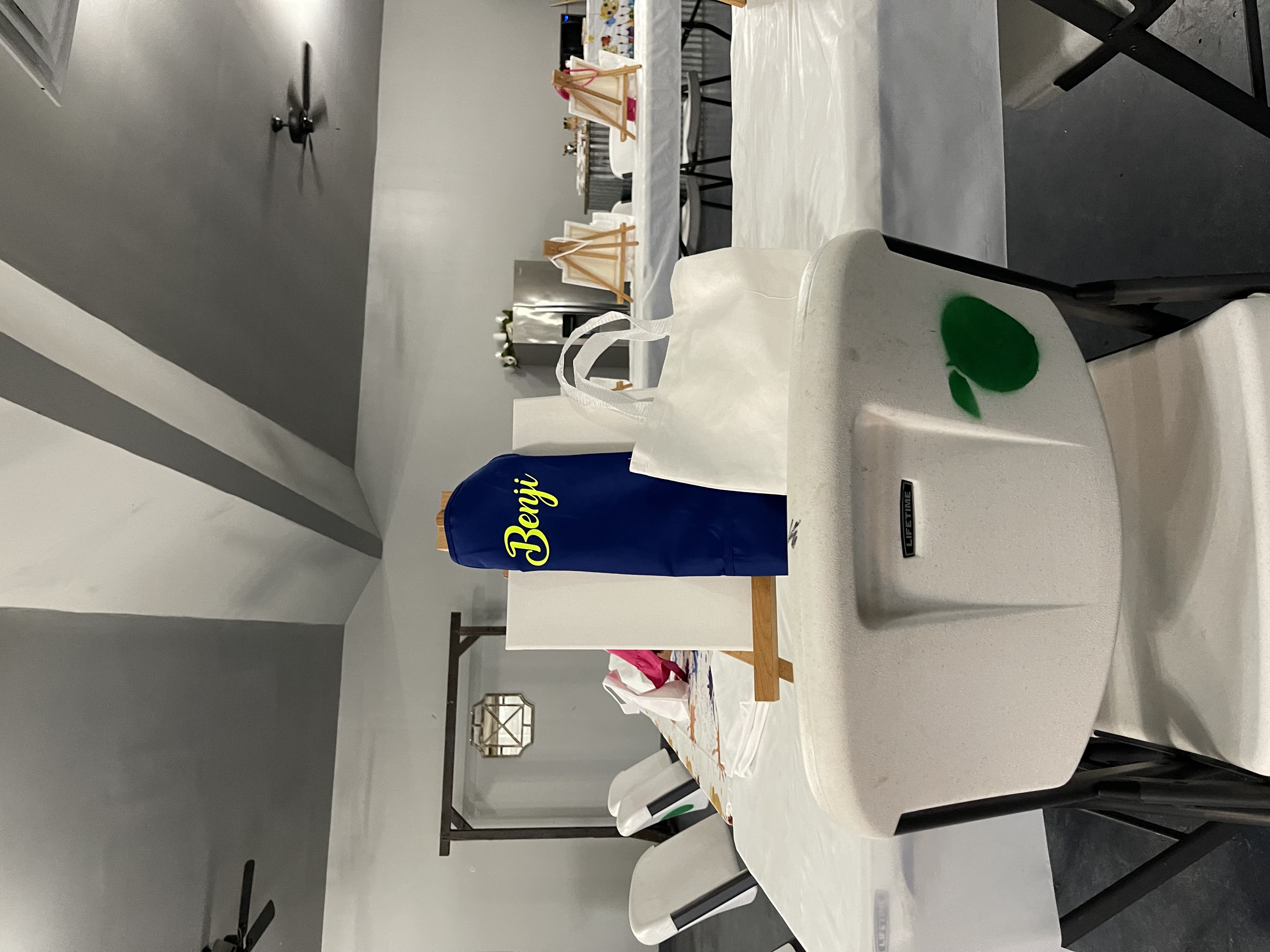 Place setting with a personalized favor bag at a paint party table
