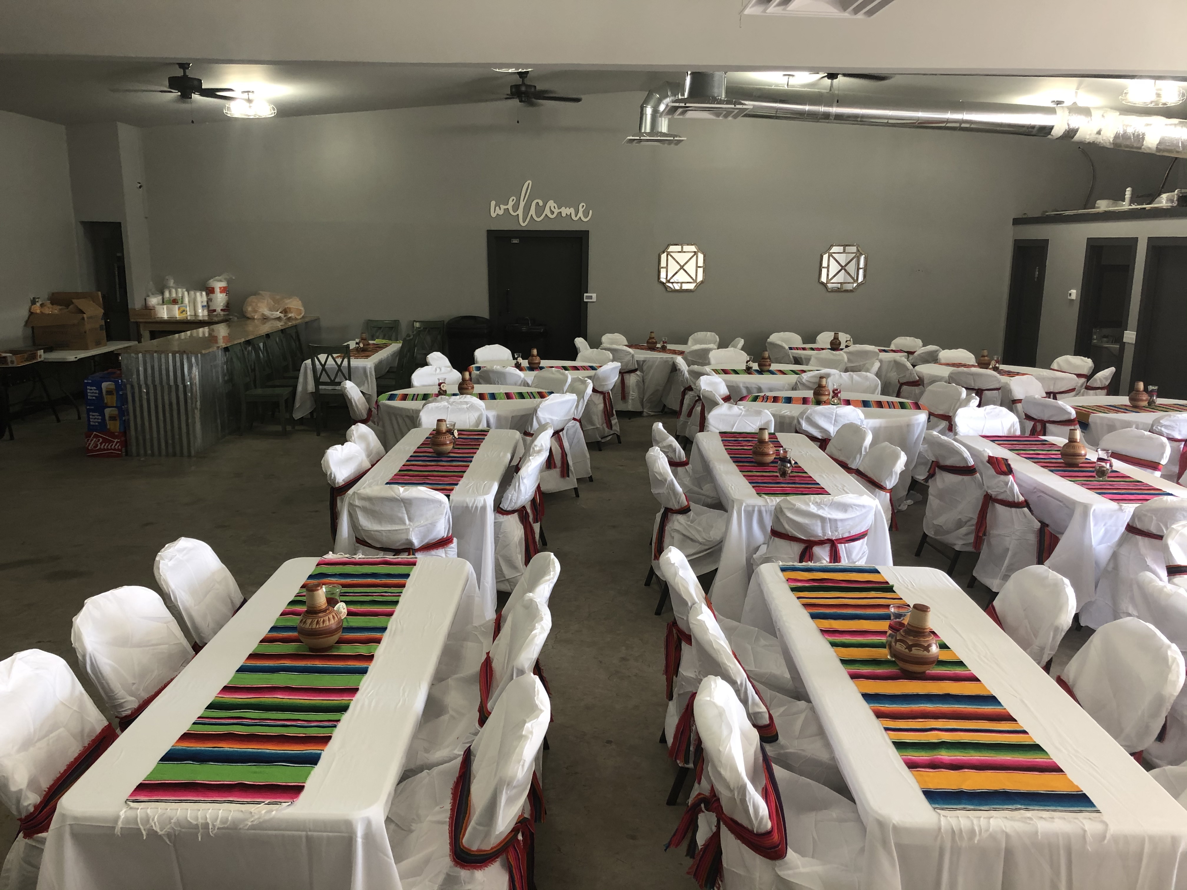 The Limon Fiesta Garden hall set with white linens, chair covers and colorful table runners