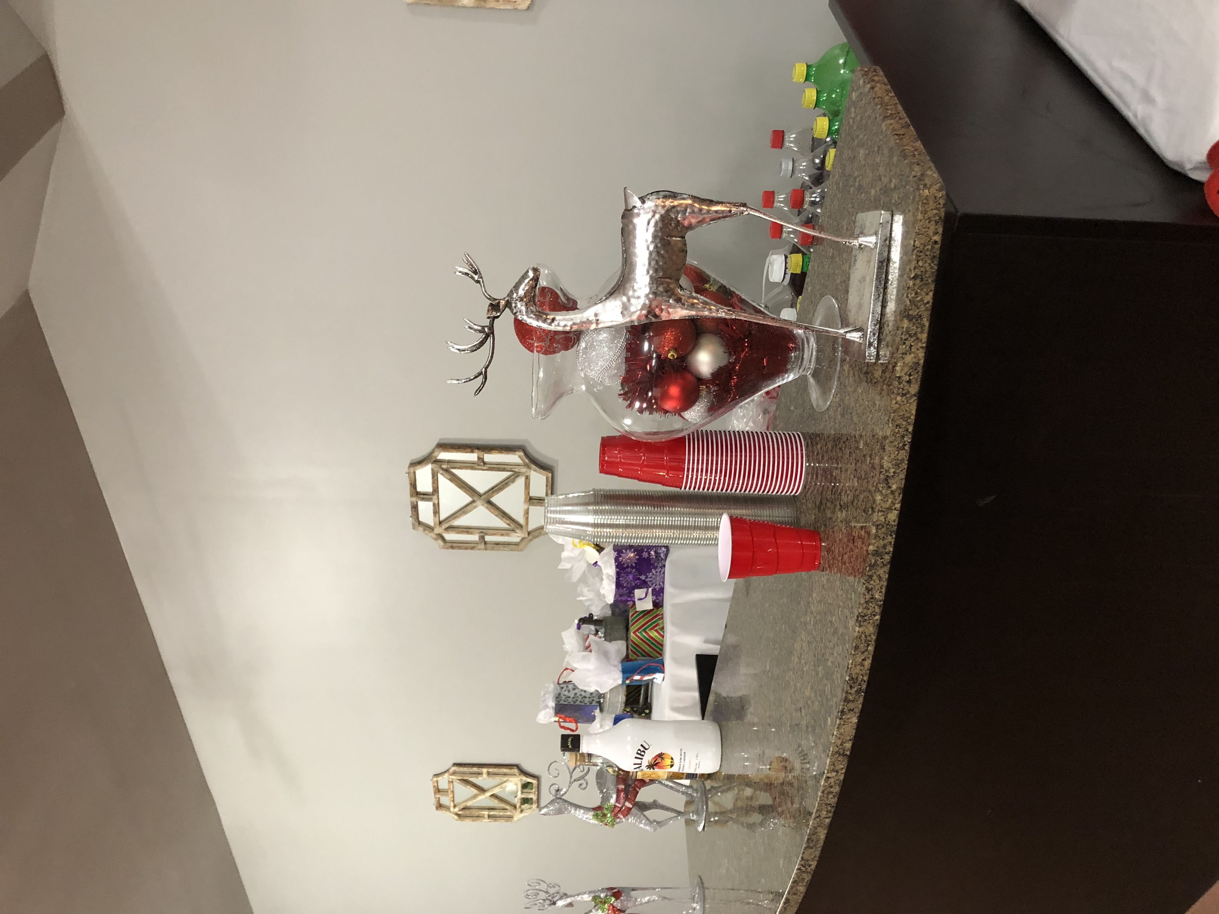 Serving counter decorated with holiday centerpieces, cups and drinks