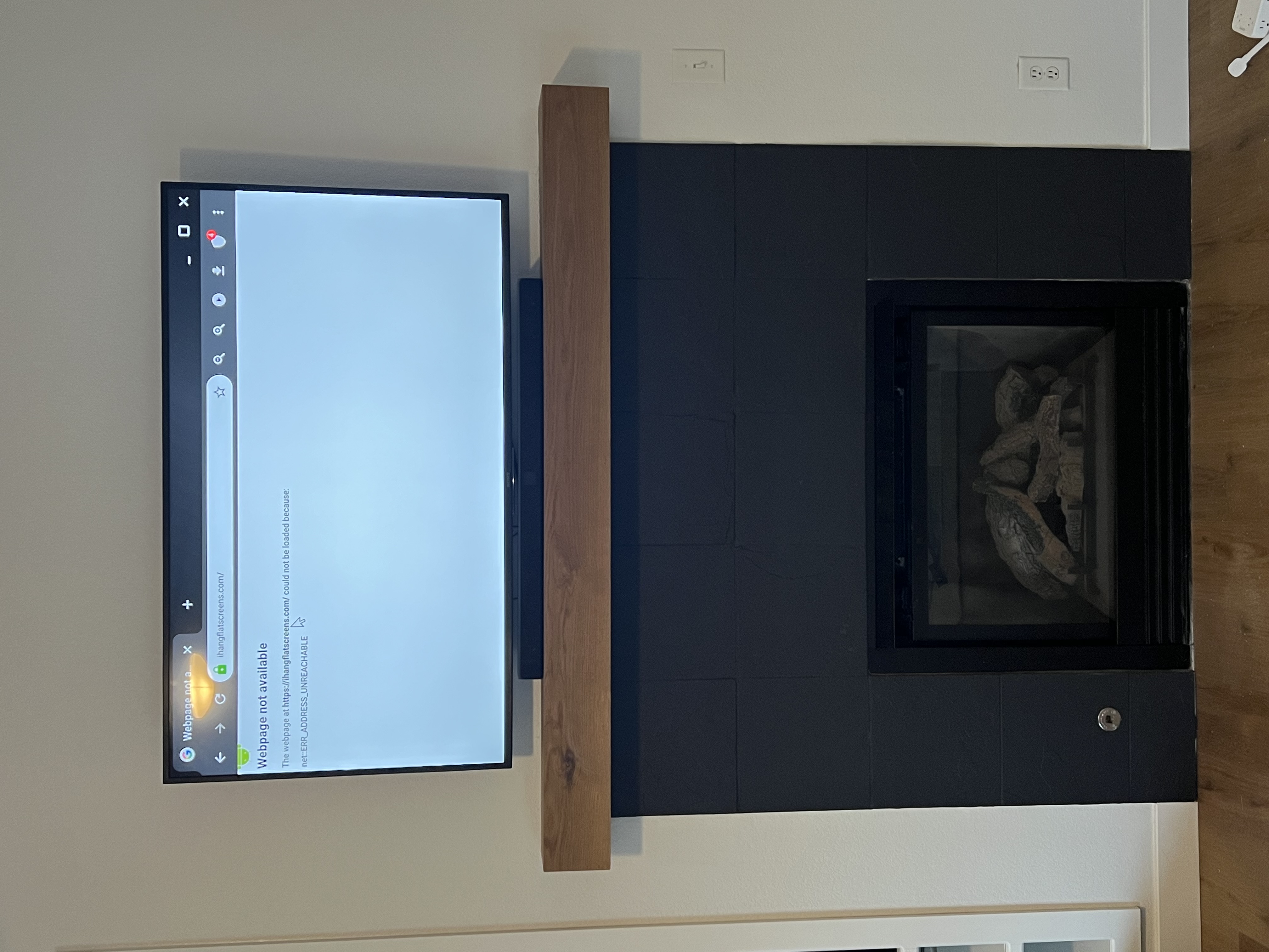 TV mounted over tile fireplace with hidden wiring by I Hang Flat Screens
