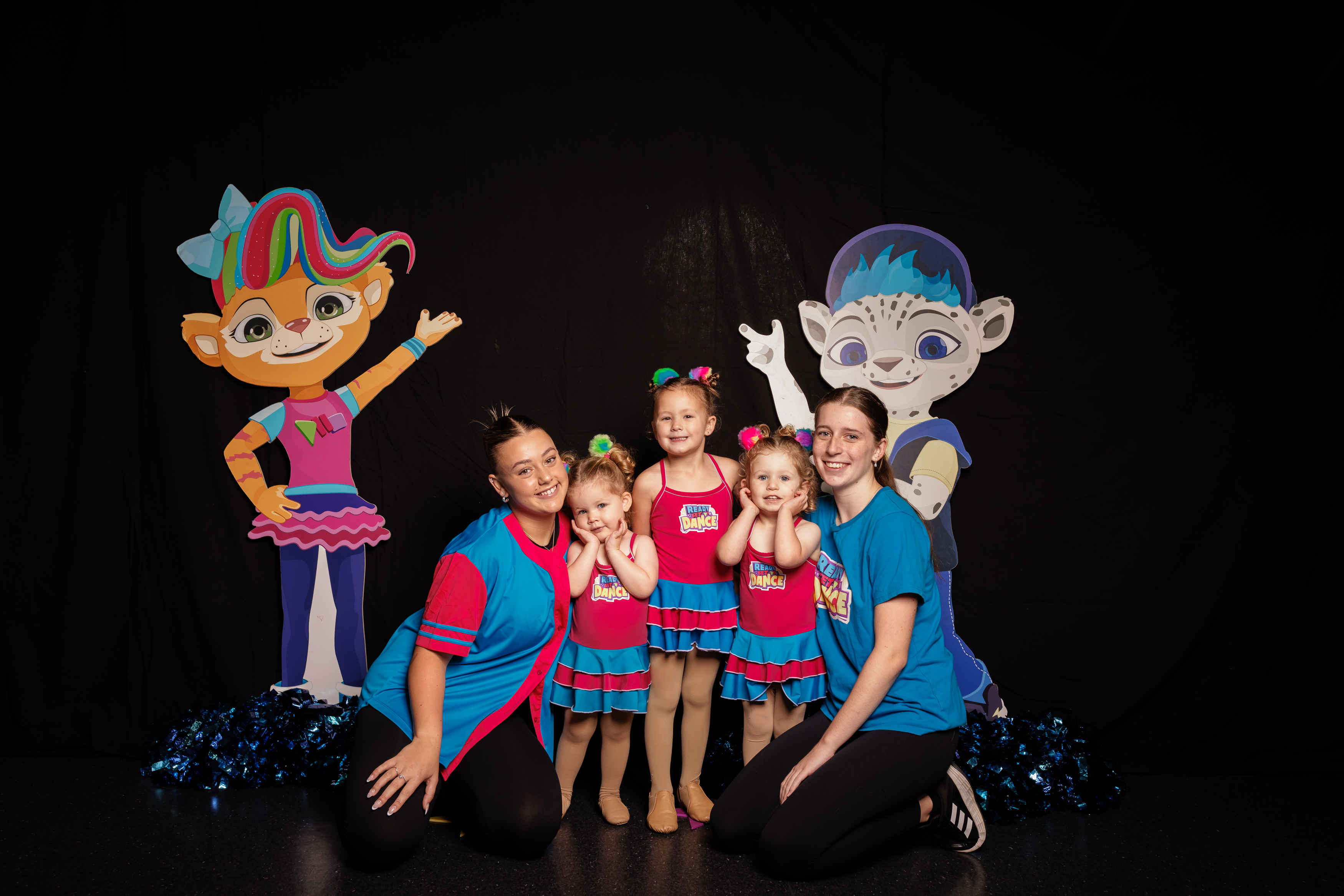 Head of pre-school teachers at KICO Dance Studios with three Ready Set Dance students, all smiling and hugging. This staged photo showcases our dedicated pre-school dance program, fostering confidence, creativity, and fun for children of all ages in the Bargo, picton area