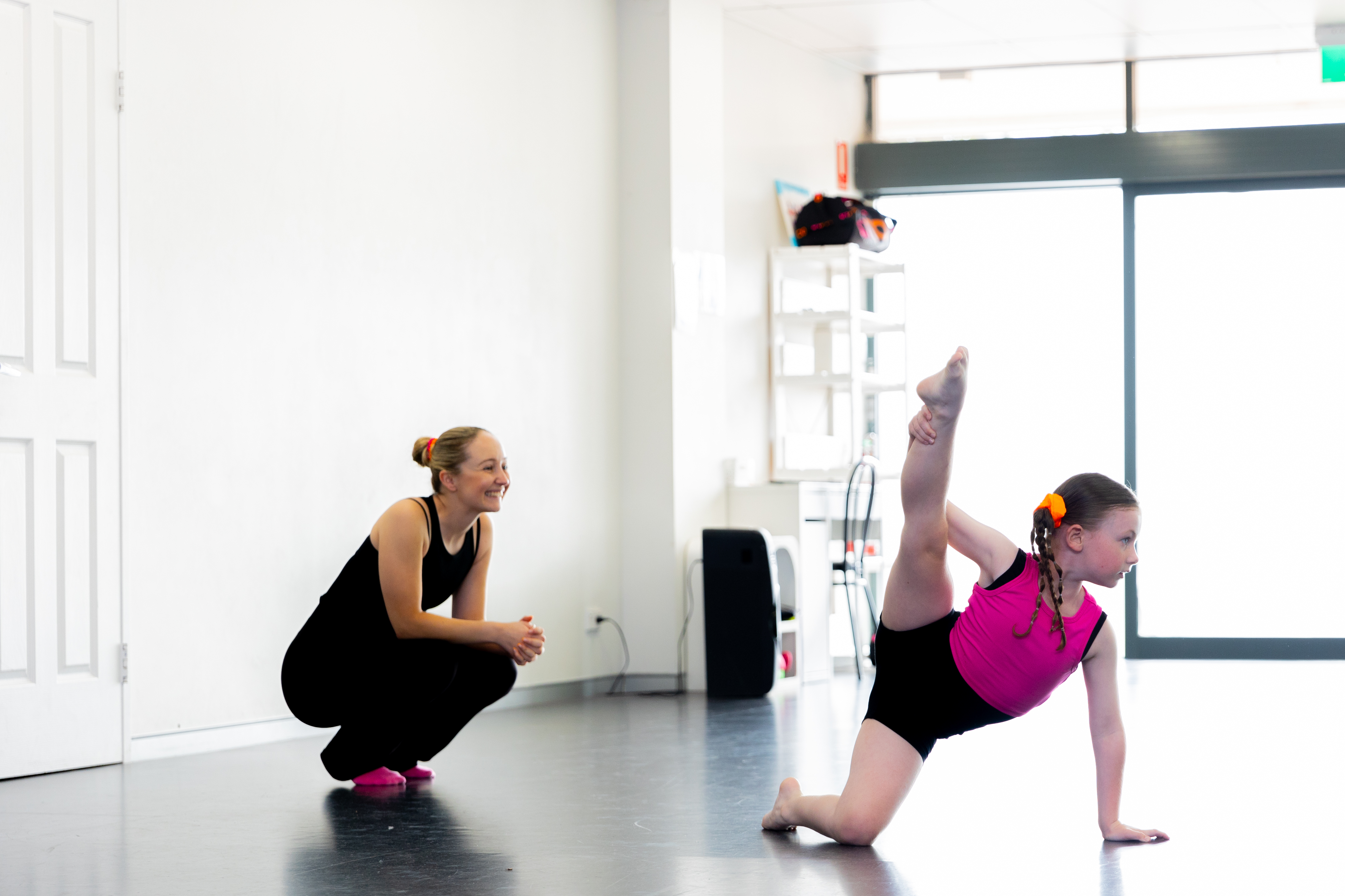 Dance teacher supporting a young dancer practising flexibility and technique at KICO Dance Studios in Bargo NSW.