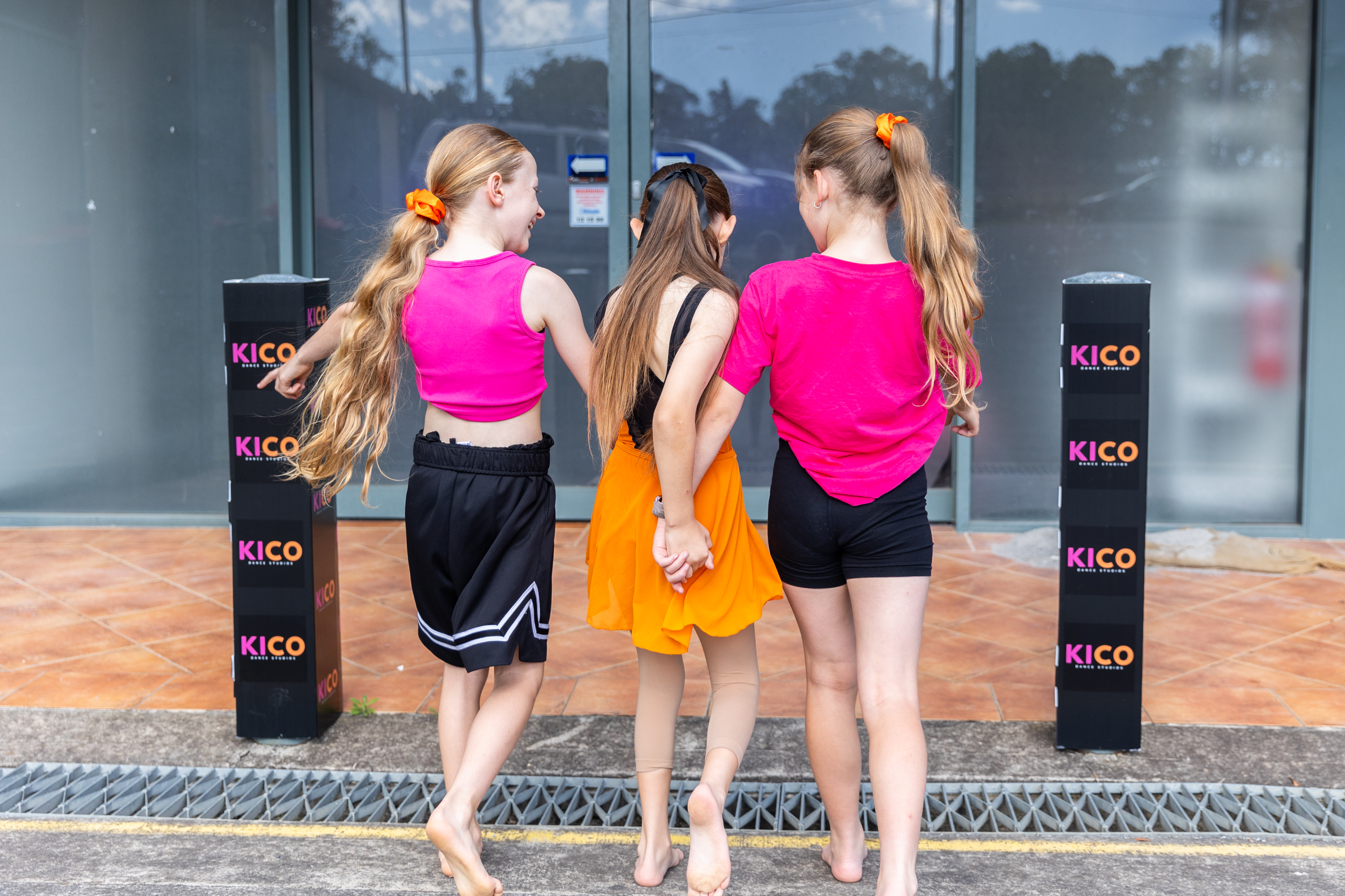 Group of young dancers walking into KICO Dance Studios, showing friendship and a welcoming dance community in Bargo