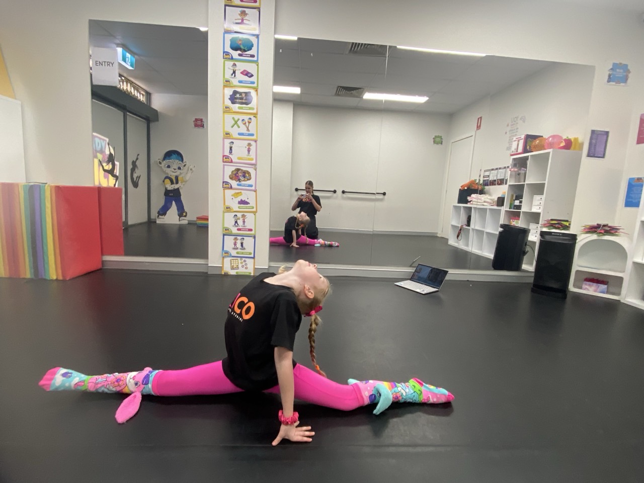 “Young dancer practising splits and flexibility training at KICO Dance Studios in Bargo NSW, developing strength and technique.