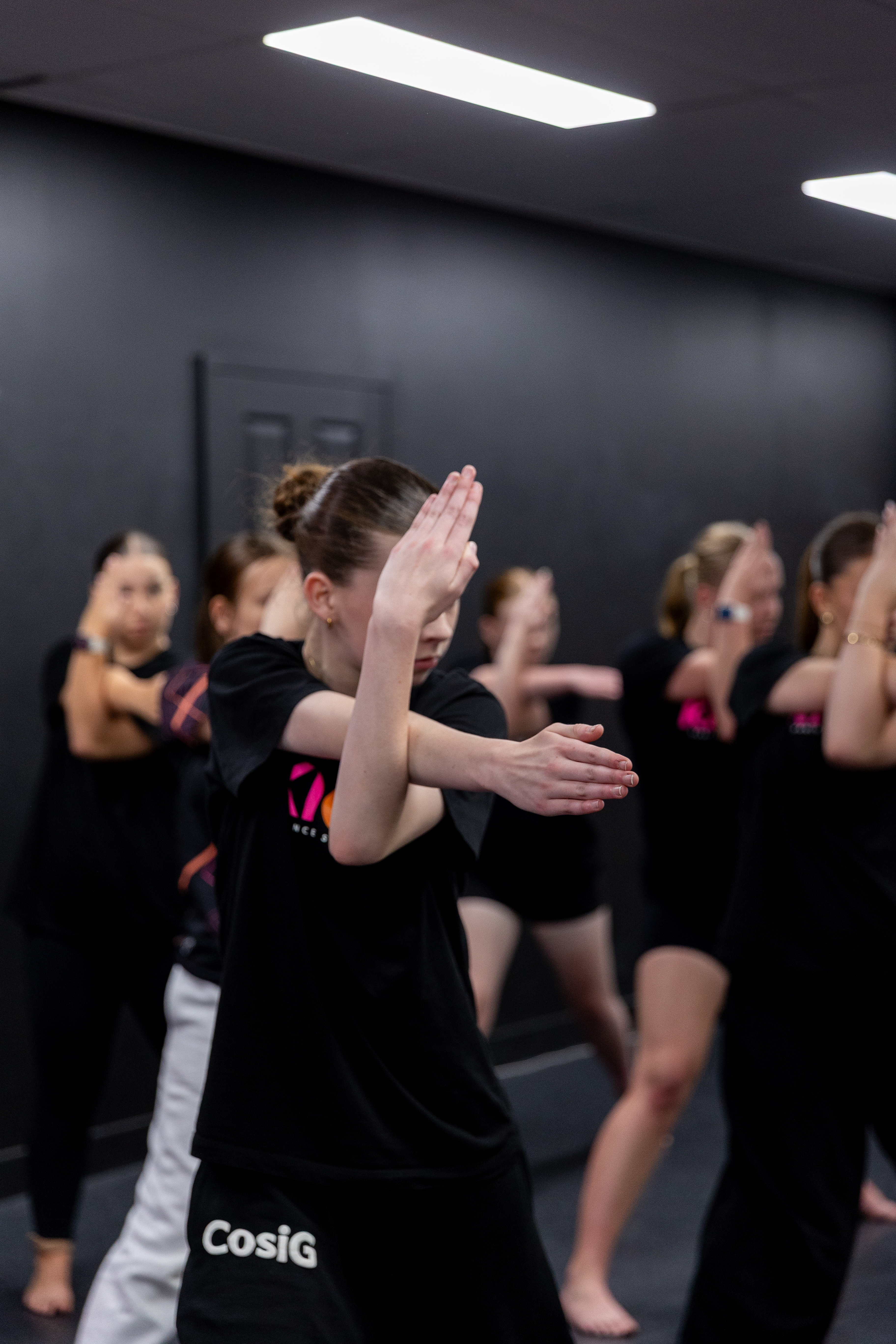 A happy family of three with girls of different ages, all taking kids' dance classes at KICO Dance Studios. The girls are building confidence and making lifelong friendships through pre-school and school-aged dance programs in a supportive environment