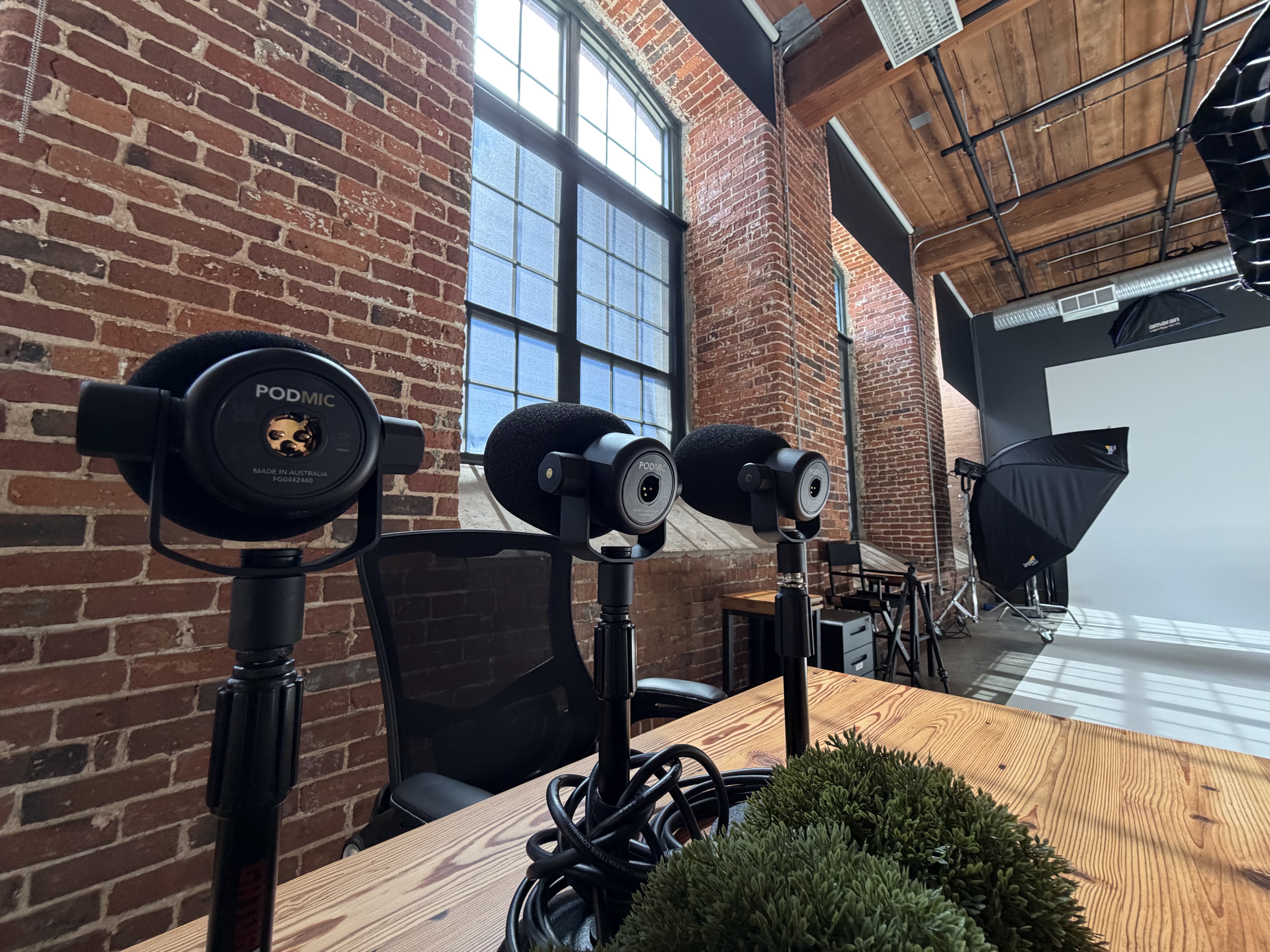 Inside Alchemy Studios near Charlotte, NC: an open set with a leather sofa, lounge chair, wardrobe rack and lighting
