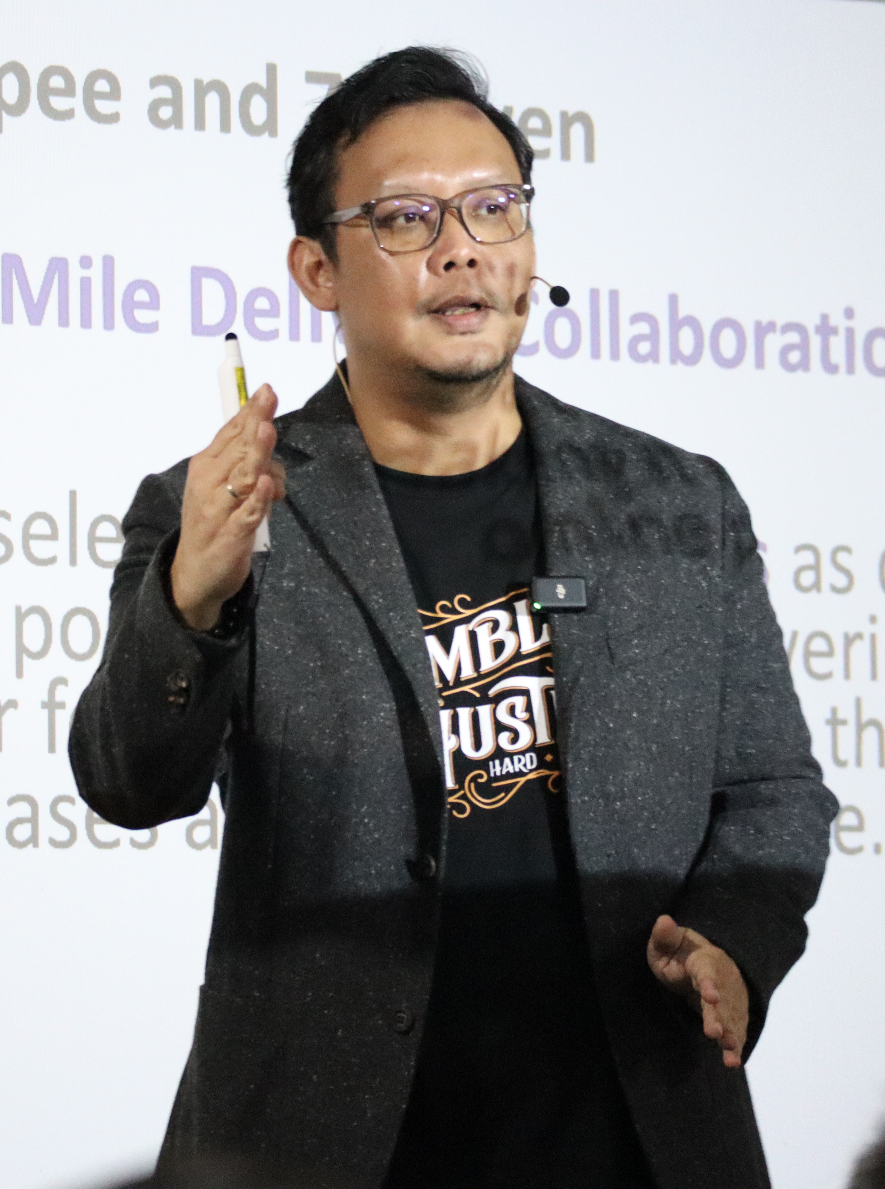 John Chong speaking on stage