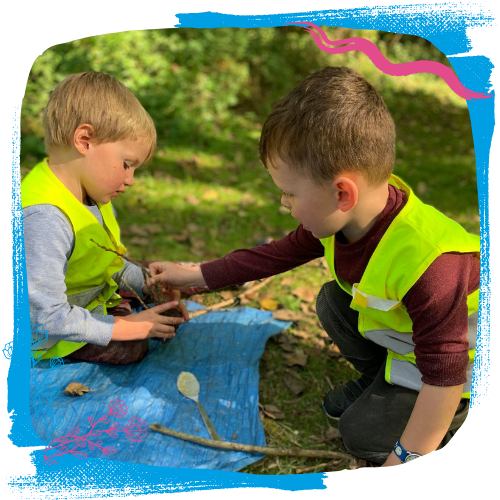 children in high vis playing with sticks