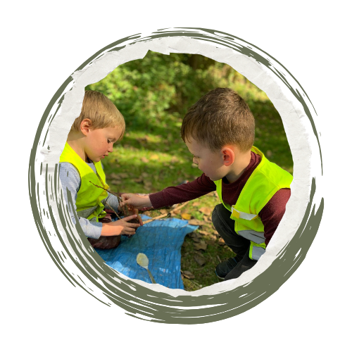 children in high vis playing with sticks